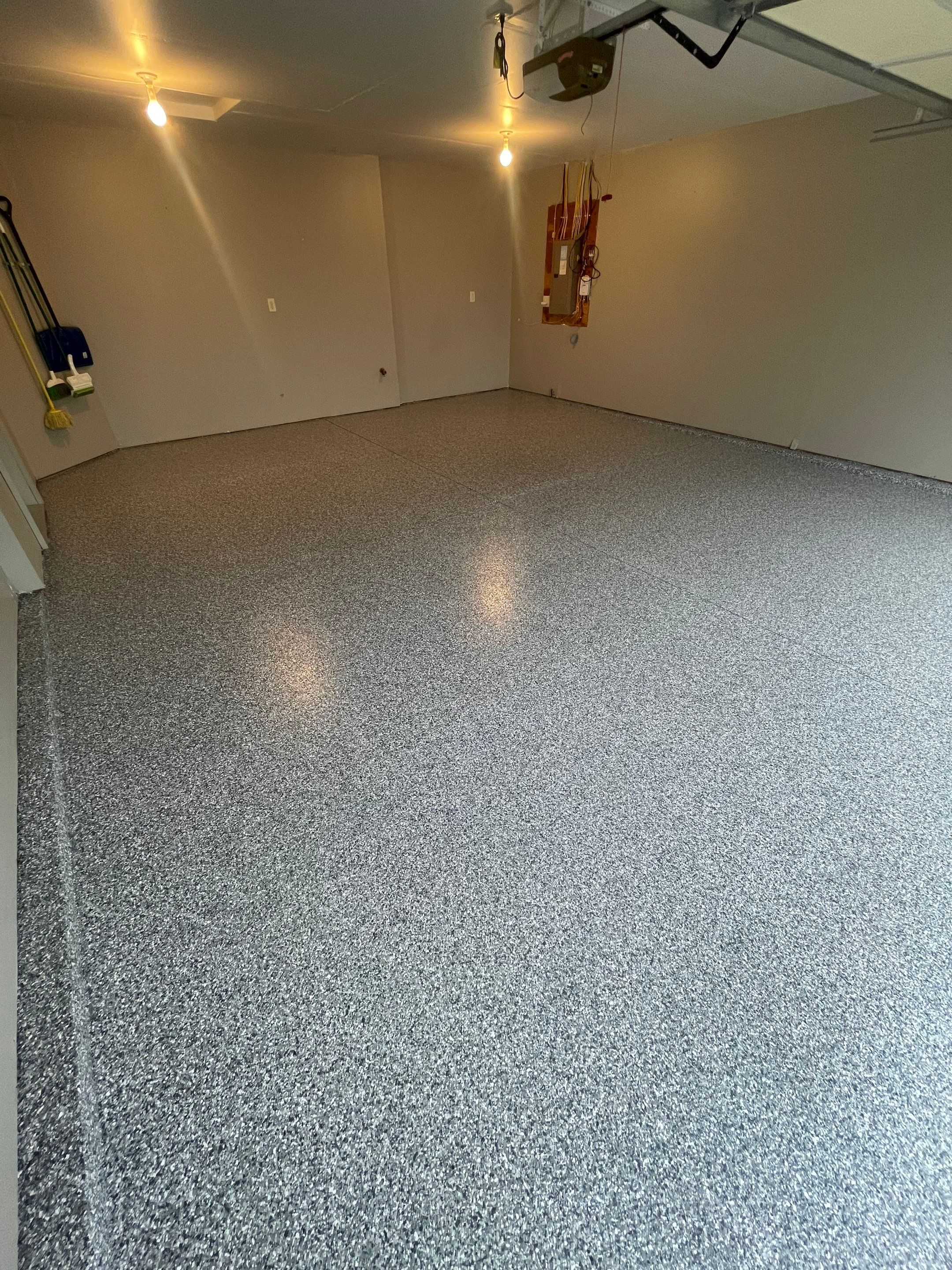 Custom Polyurea Flake Garage Floor Installation in Sioux Falls by Select Painting, Coatings & Garage Cabinets