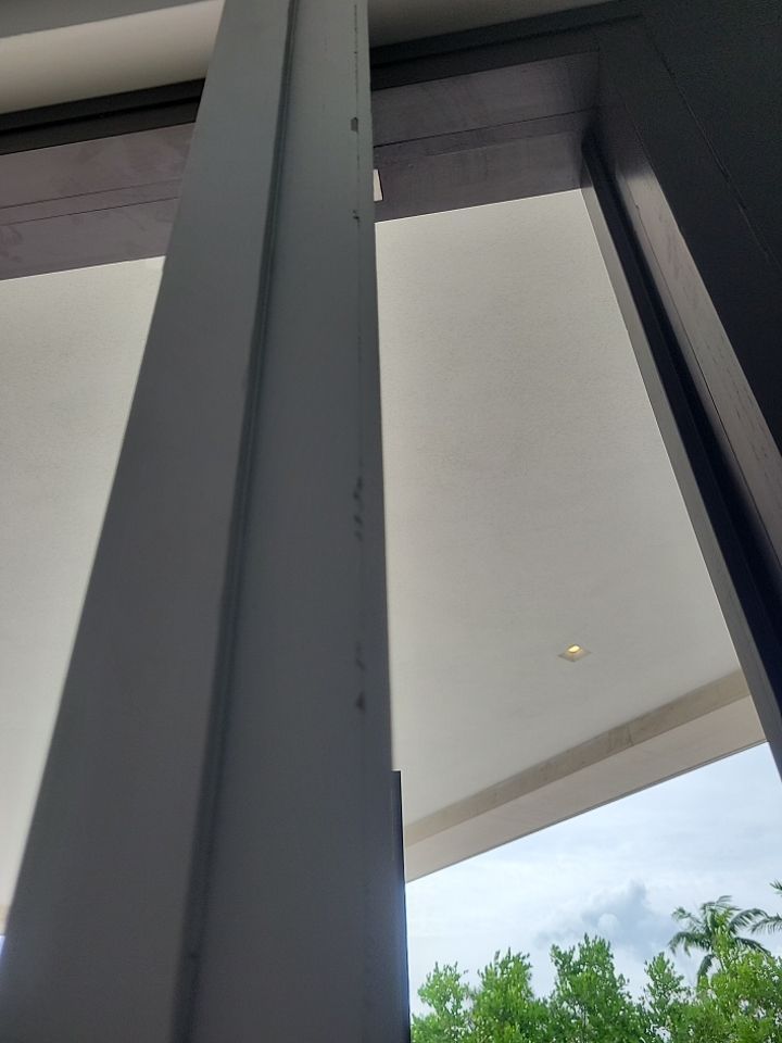 Custom Material Pivot Door installation by Impact Precious Wood Inc.