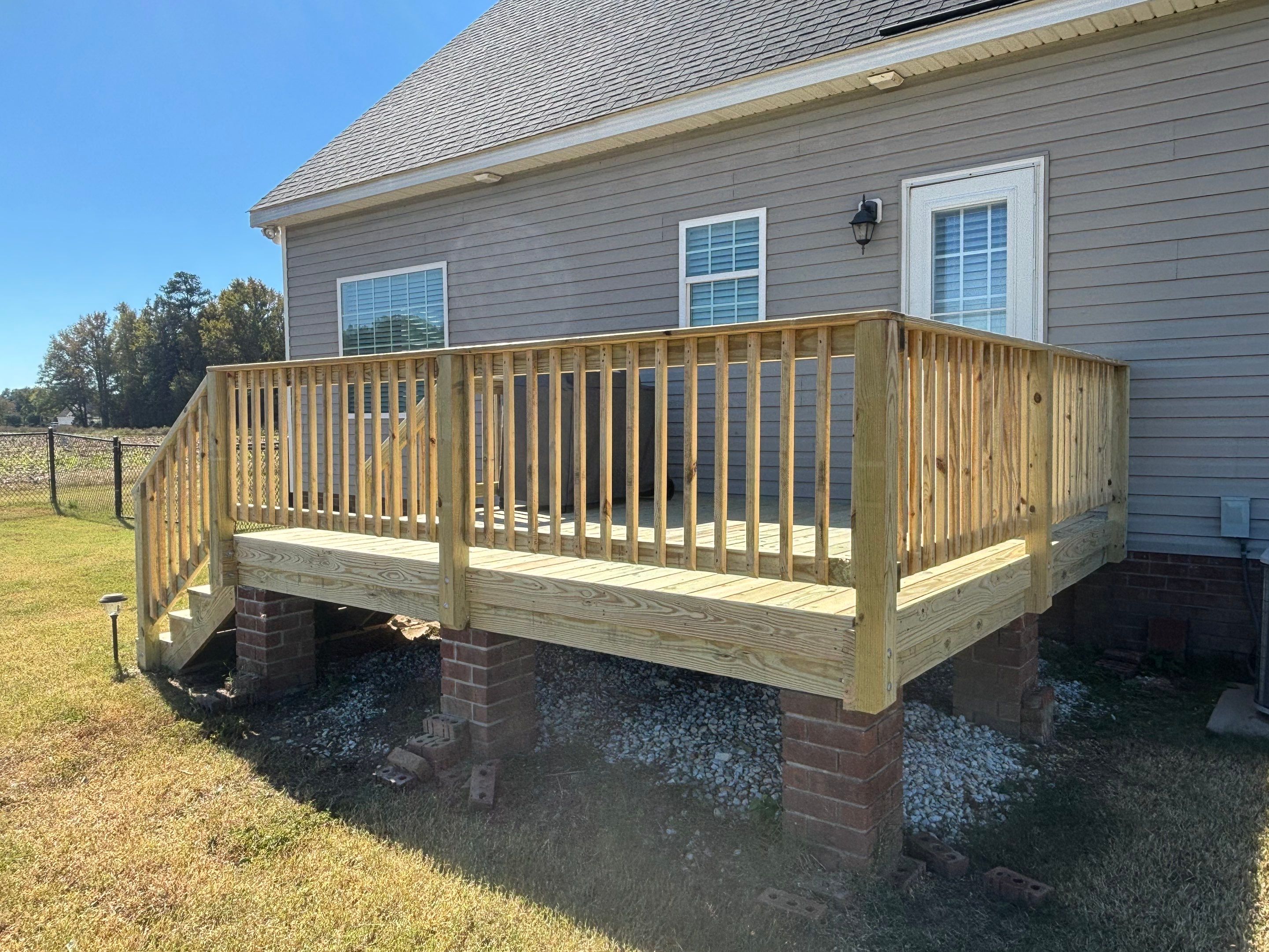 Pressure-Treated Wood Deck Resurface and Railing Replacement in Battleboro by The Remodeling Company