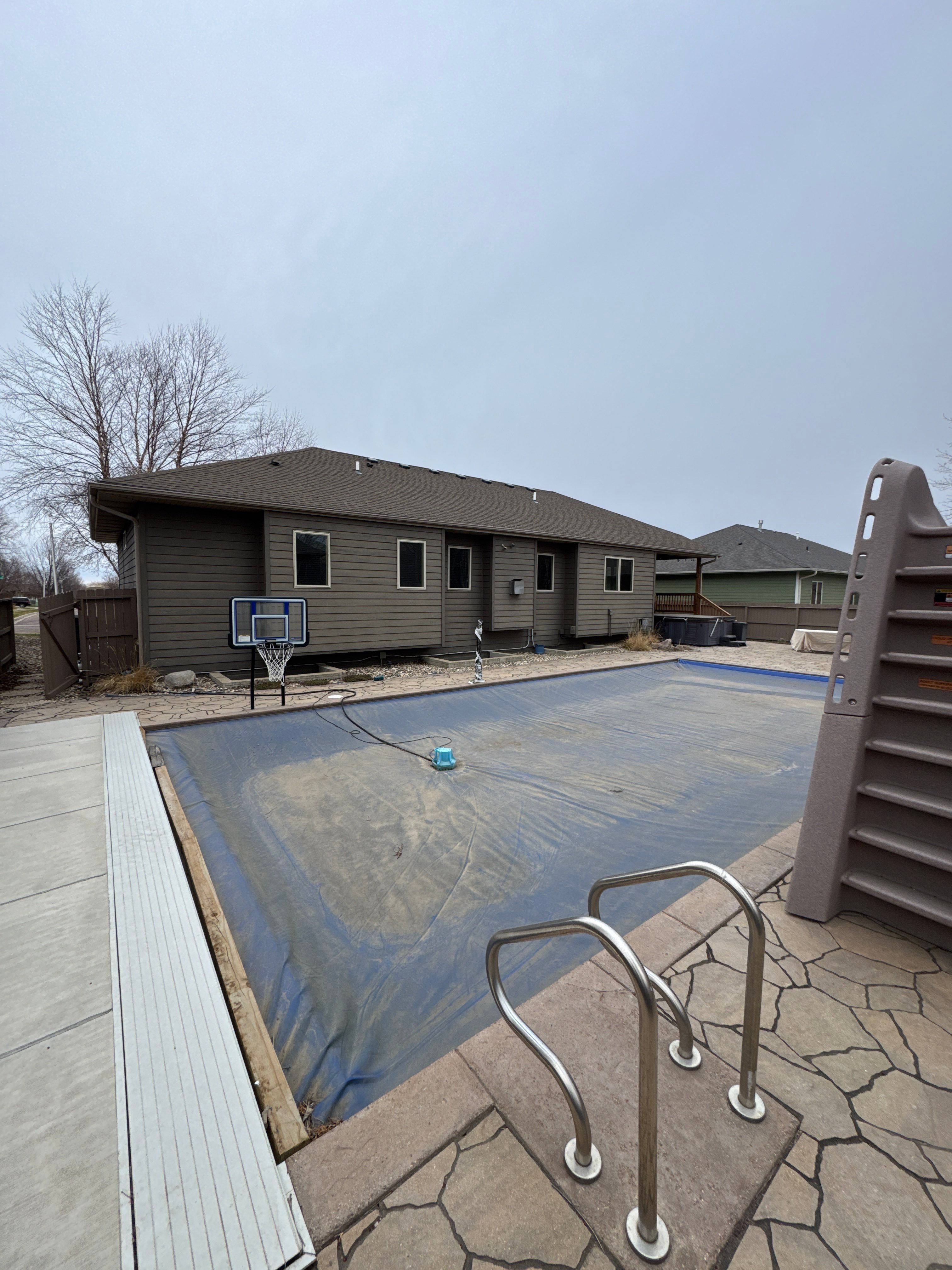 Sioux Falls Residential Exterior Update and Flagstone Pool Deck by Select Painting, Coatings & Garage Cabinets