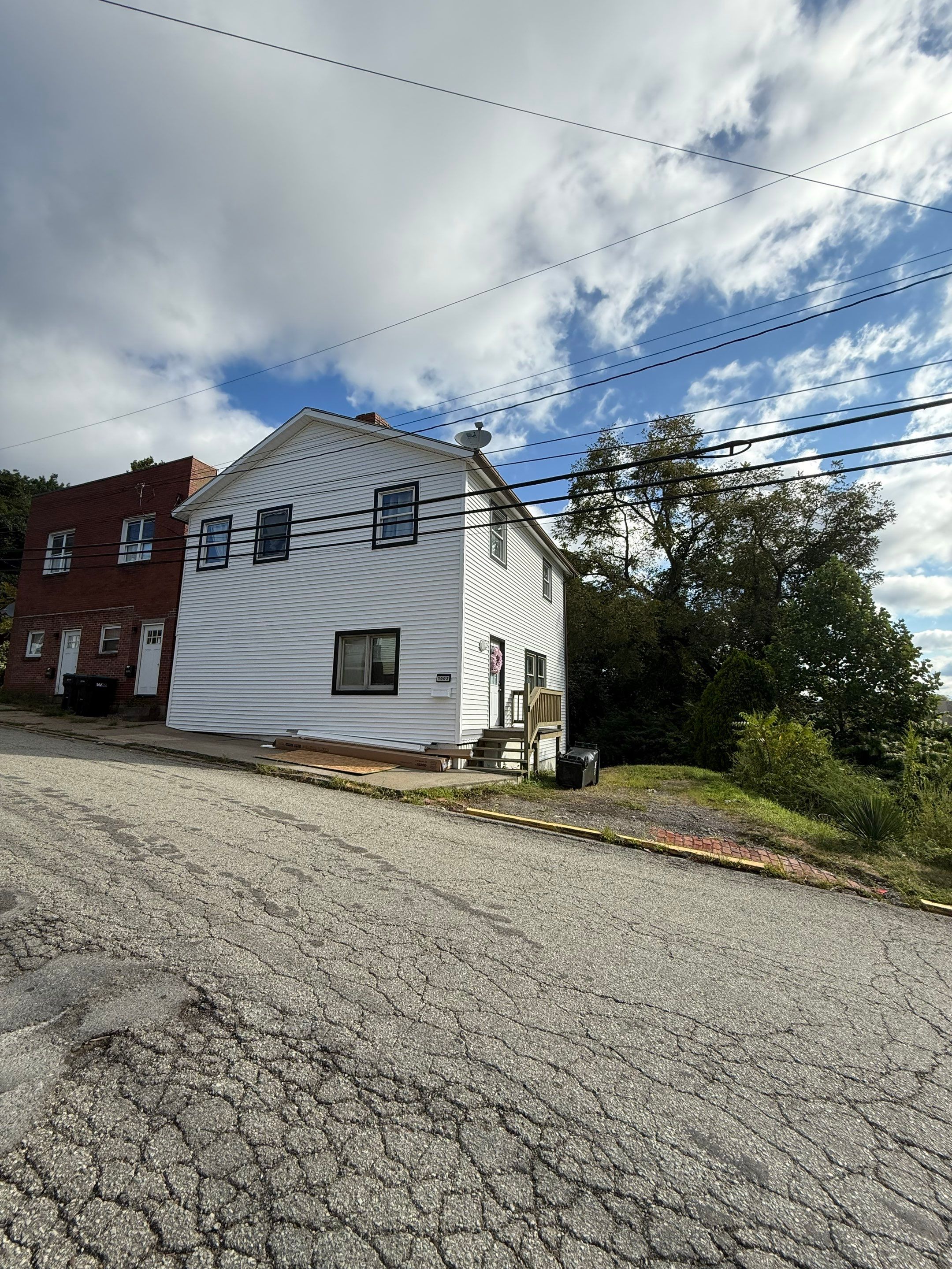 White siding  by Cousins Roofing Siding & Decks