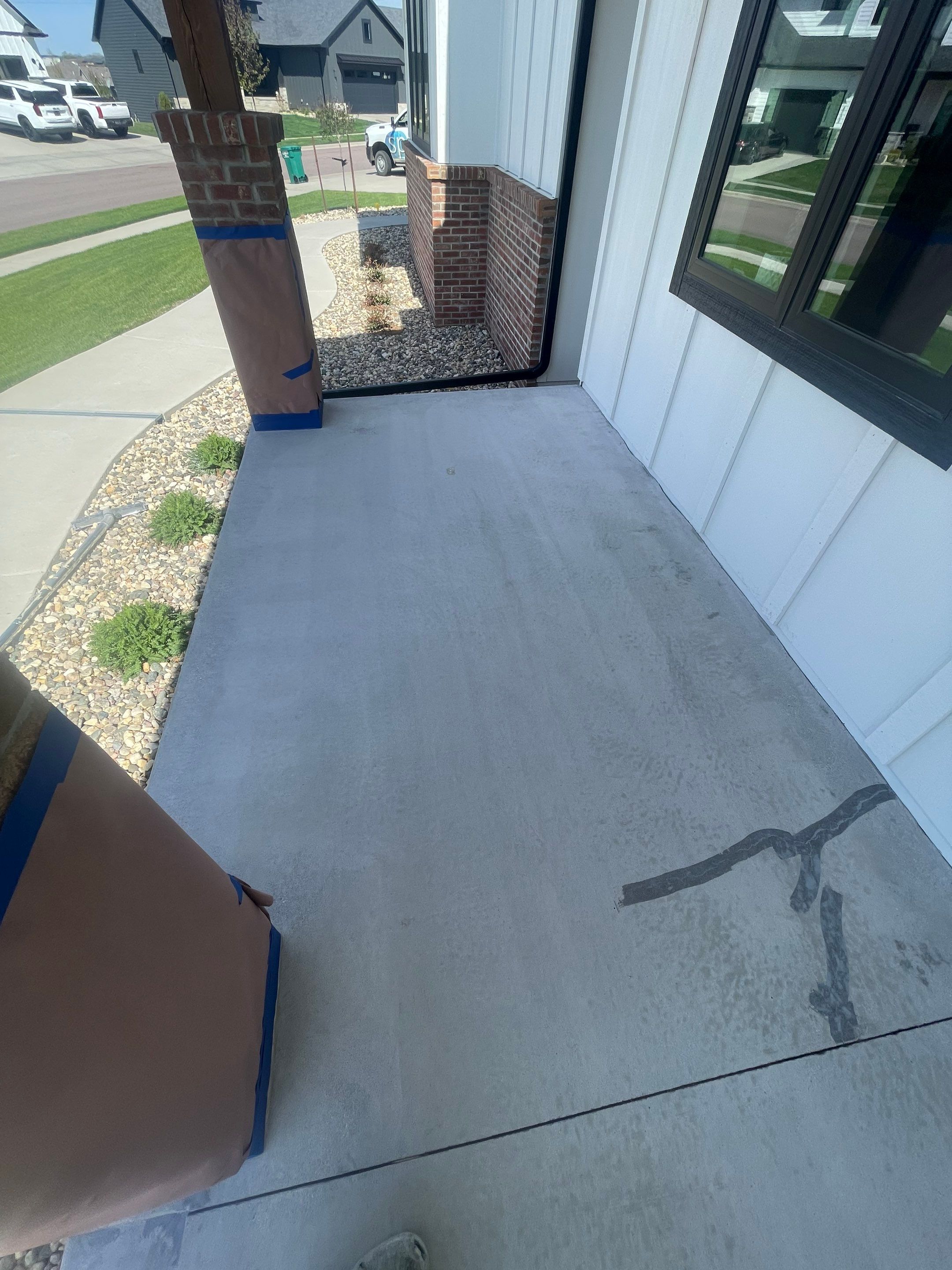 Grey Speckled Concrete Porch Coating for Sioux Falls Home by Select Painting, Coatings & Garage Cabinets