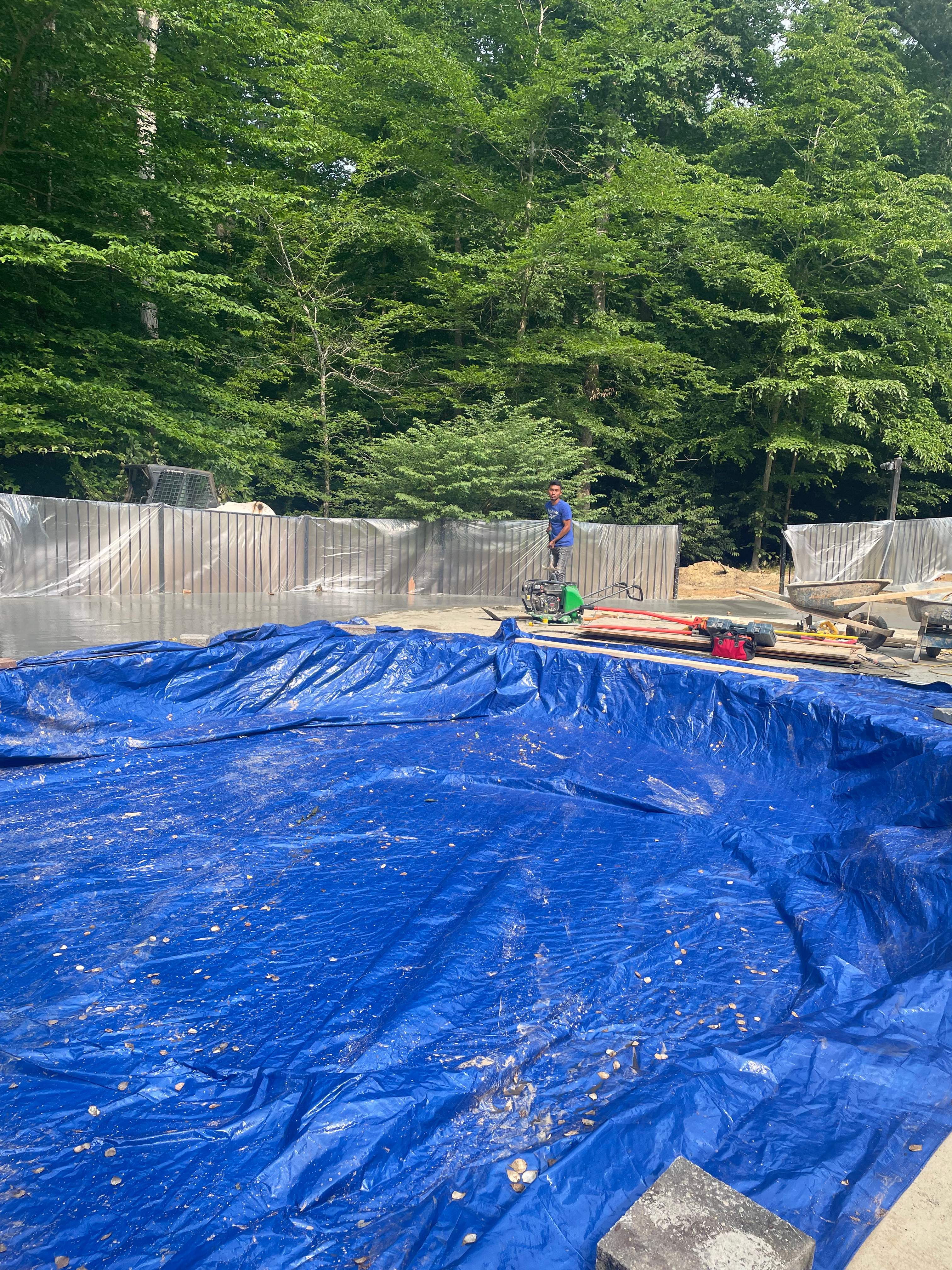 Pool Surround remodel with retaining walls, new waterfall and water slide by Fairfax Contractors, LLC