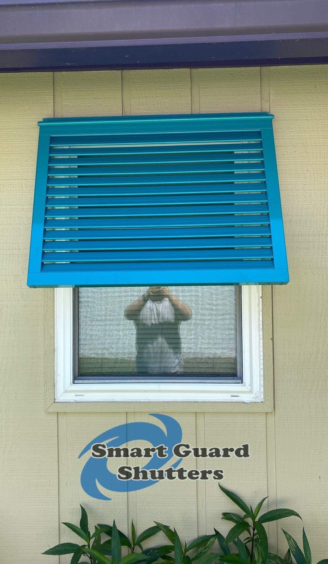 Decorative Bahama Shutters in Turquoise Blue  by Smart Guard Shutters