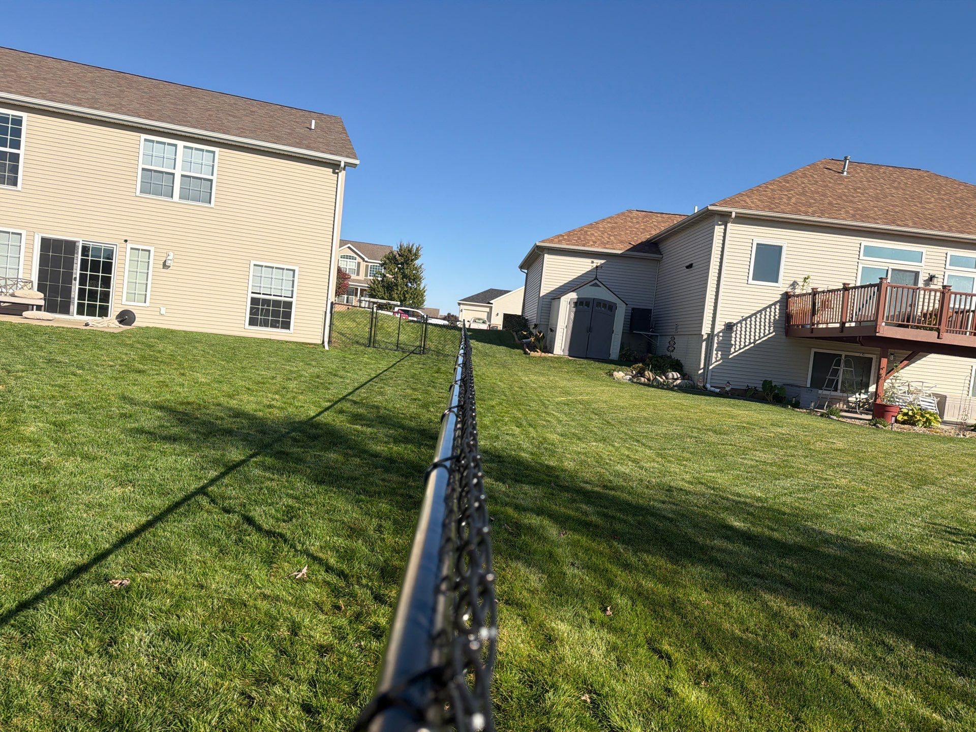Black Vinyl-Coated Chain Link Fence Installation in Cedar Falls by Perfect Picket Fence and Stain