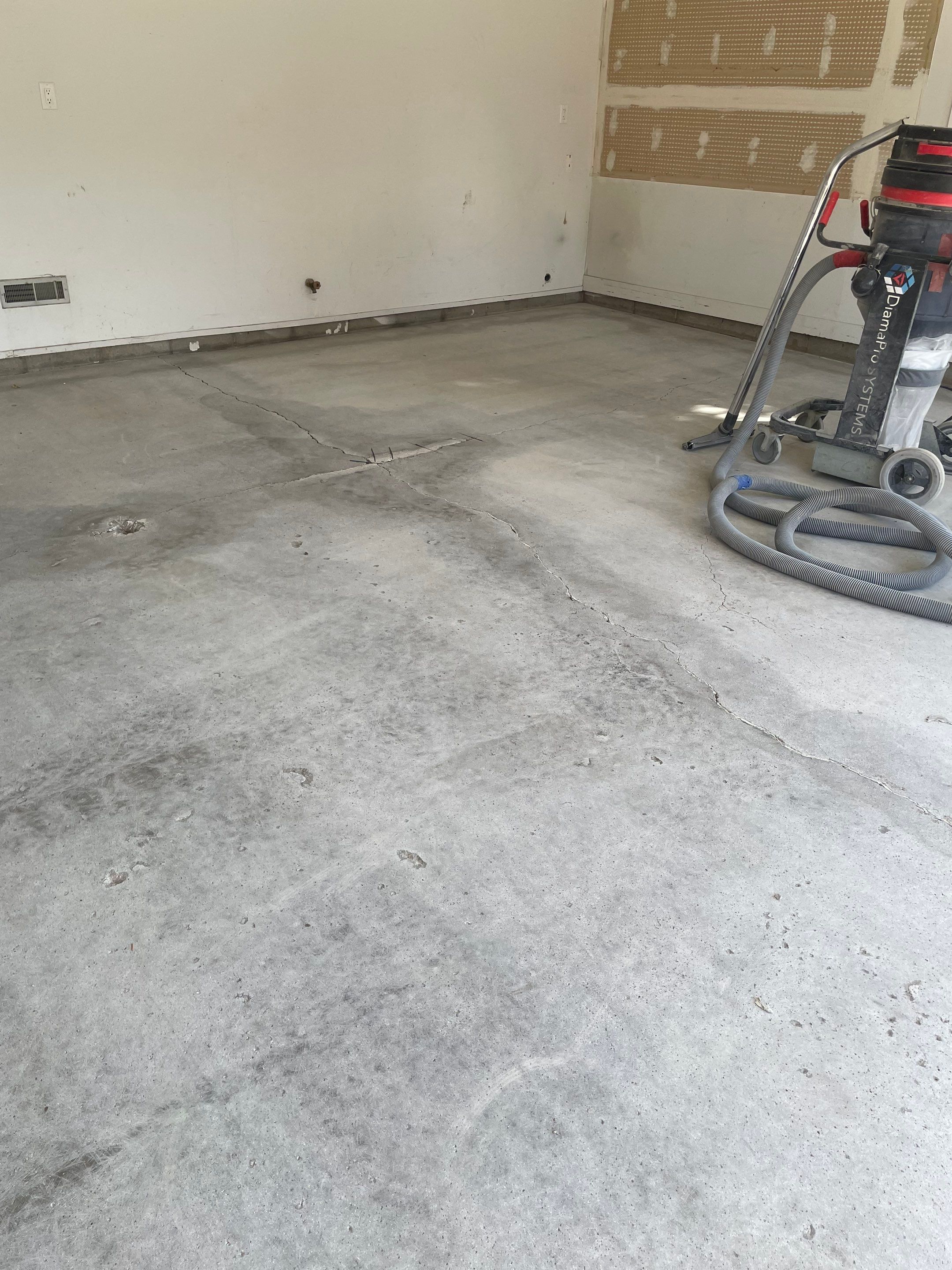 Grey Speckled Concrete Coating for Residential Garage in Yankton by Select Painting, Coatings & Garage Cabinets