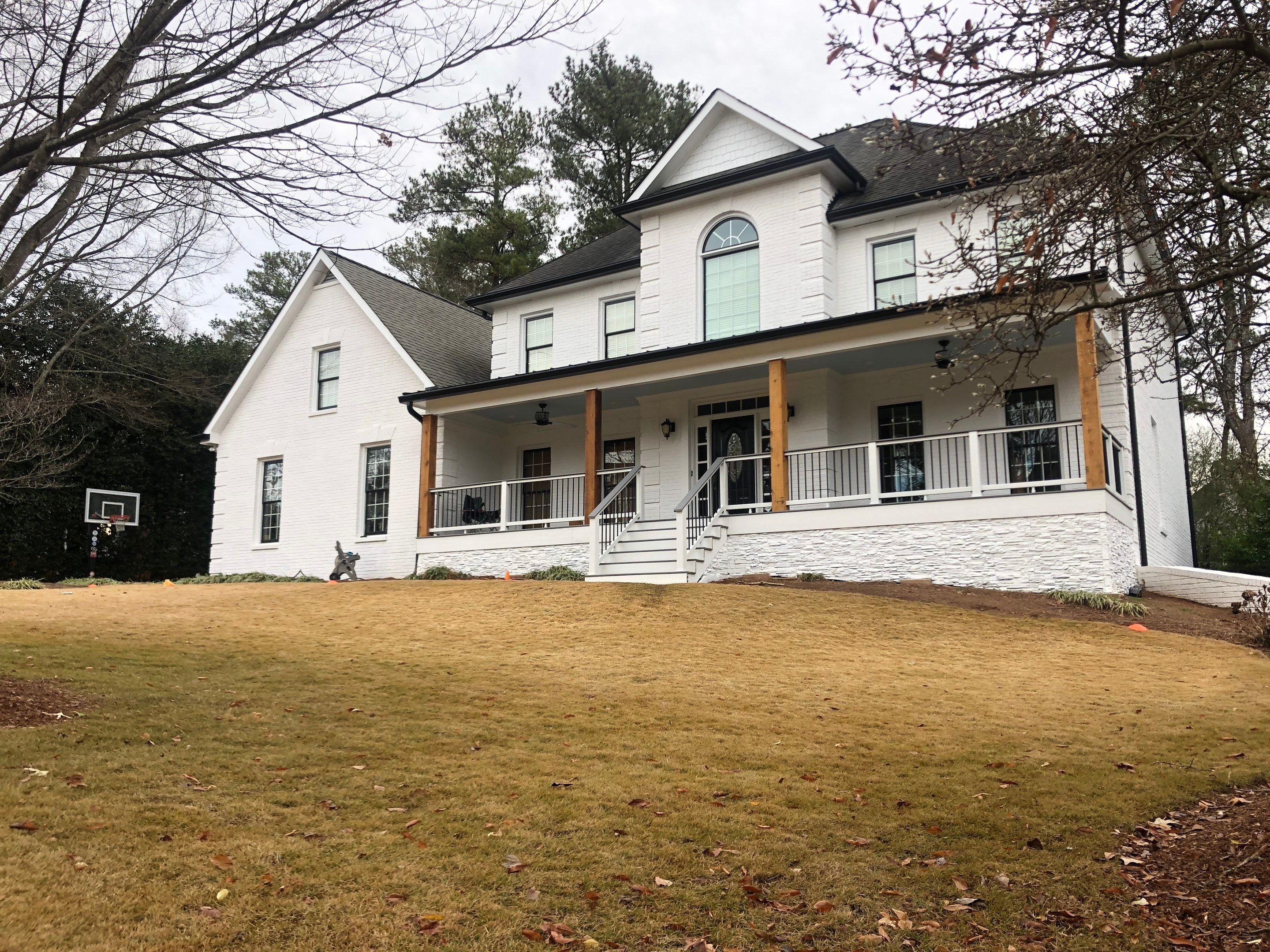 Custom Front Porch Construction with White Railing in Dunwoody by Swift Home Renovations