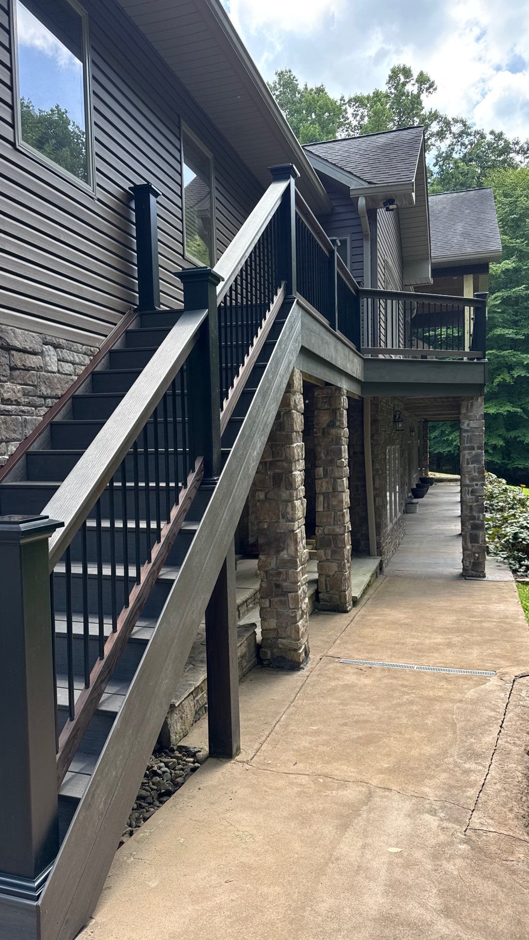 Custom Composite Deck Construction with Stone Pillars in Fayetteville by Walnut Hollow Decks & Outdoor Living