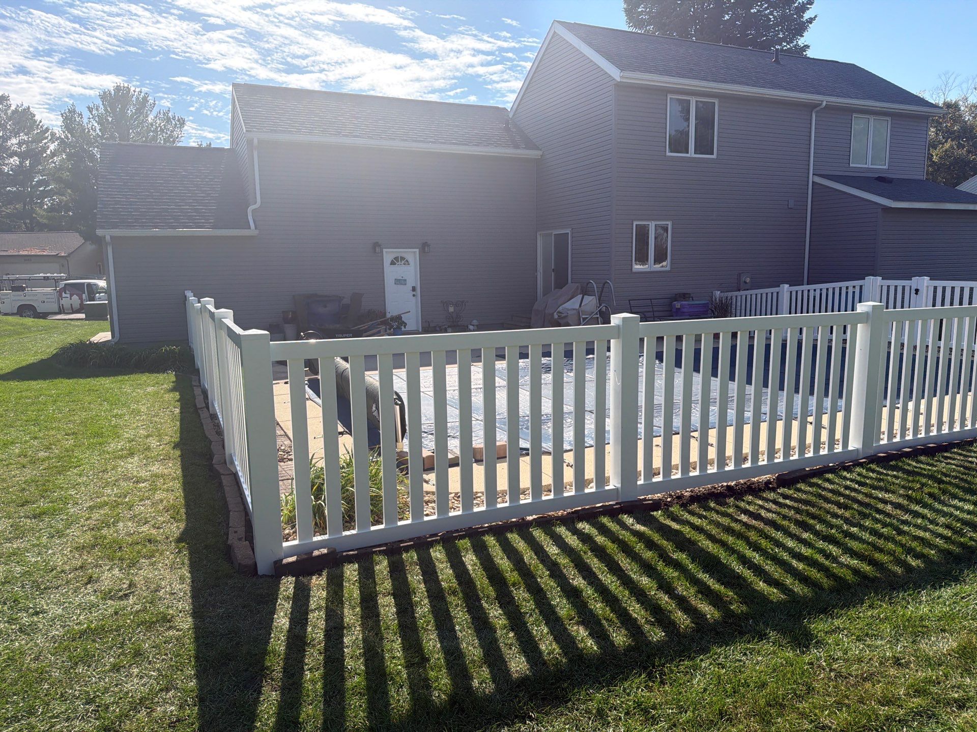 White Vinyl Picket Pool Fence Installation in Waterloo, Iowa by Perfect Picket Fence and Stain