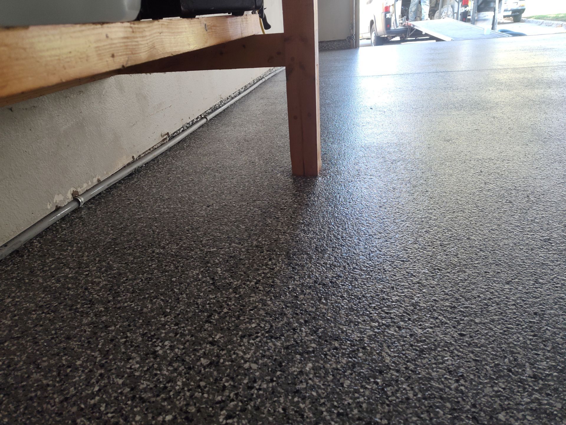 Close Up View of This Customer's New Flake Coating by Revival Concrete Coatings