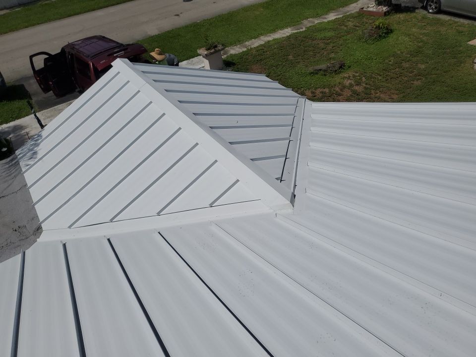Residential Roofing Installation using 1.5" Nail Strip 24ga Solar White Kynar Coated Standing Seam Metal Panels by Morton Roofing, Inc.