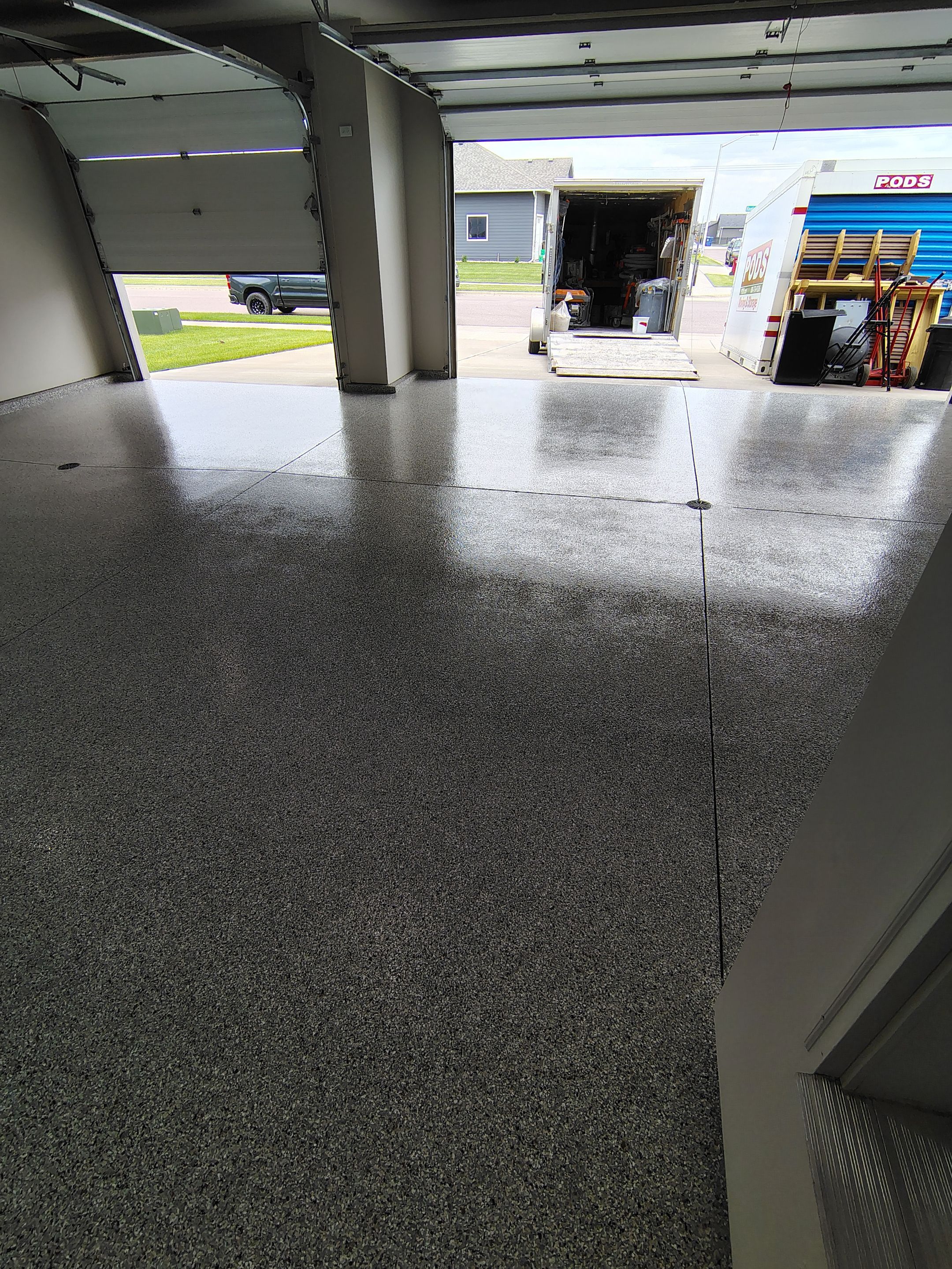 Grey Speckled Epoxy Garage Floor Coating in Sioux Falls by Select Painting, Coatings & Garage Cabinets