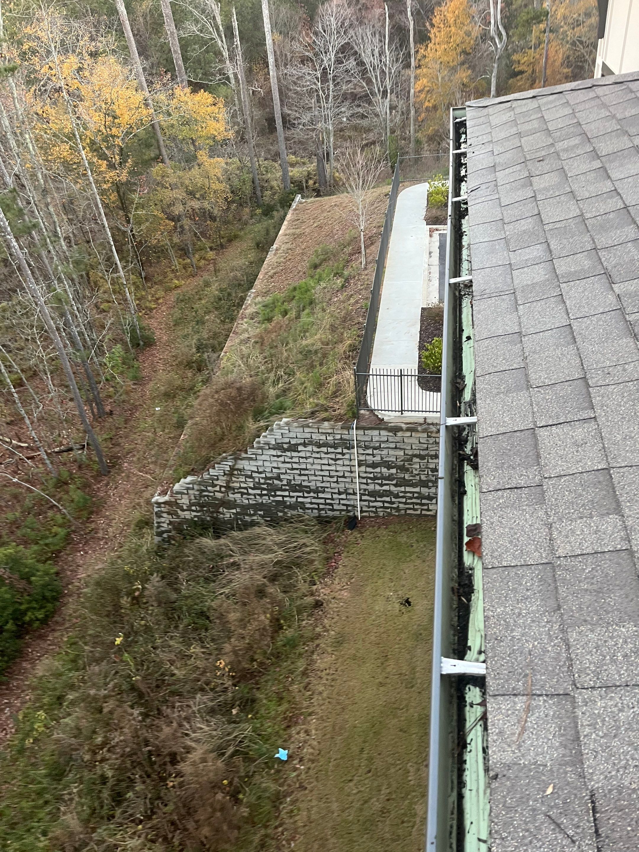 HOA gutter cleaning in Newnan, GA, after  photo showing full gutters.