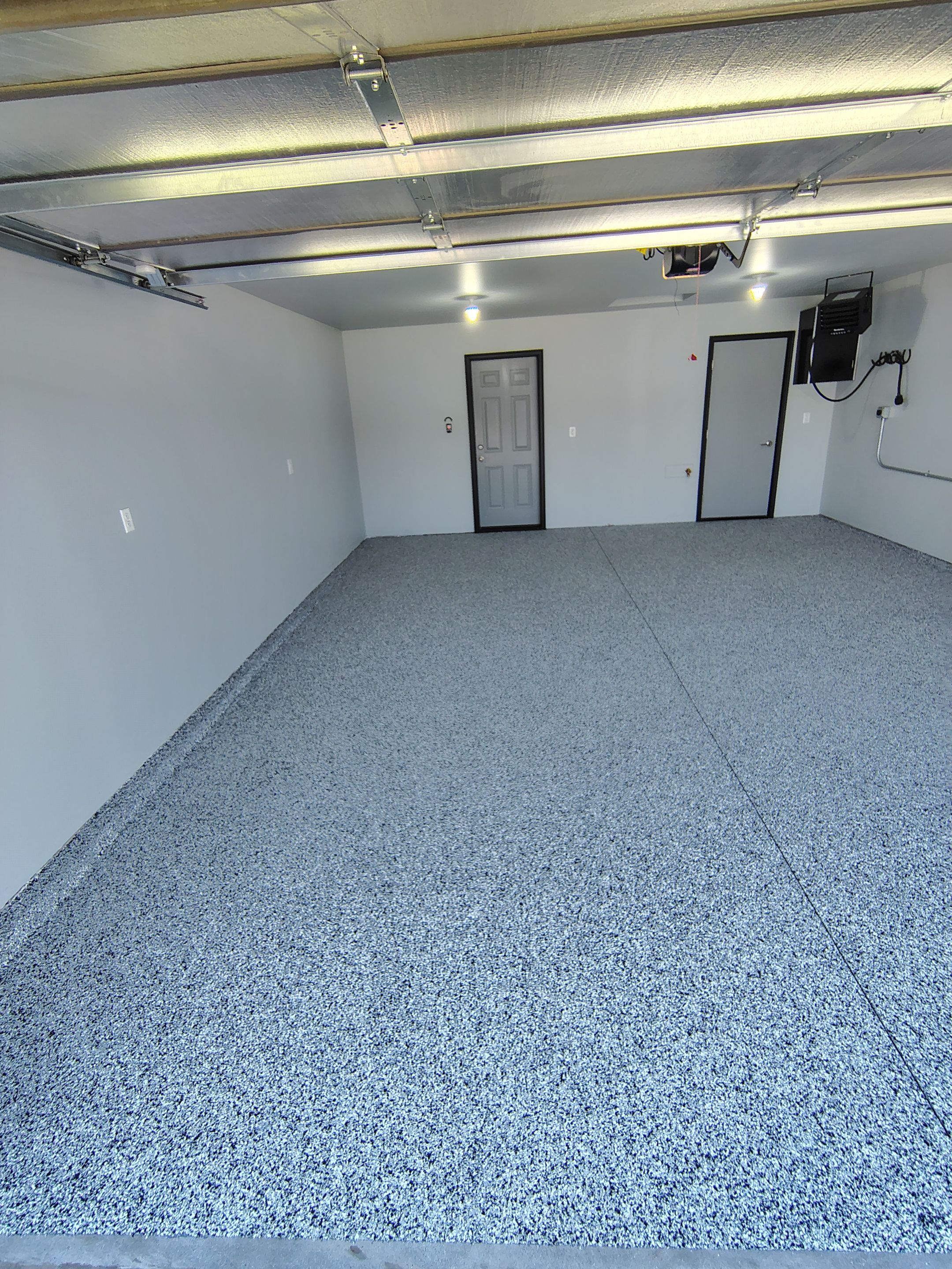 Custom Epoxy Garage Floor Coating Installation in Sioux Falls by Select Painting, Coatings & Garage Cabinets