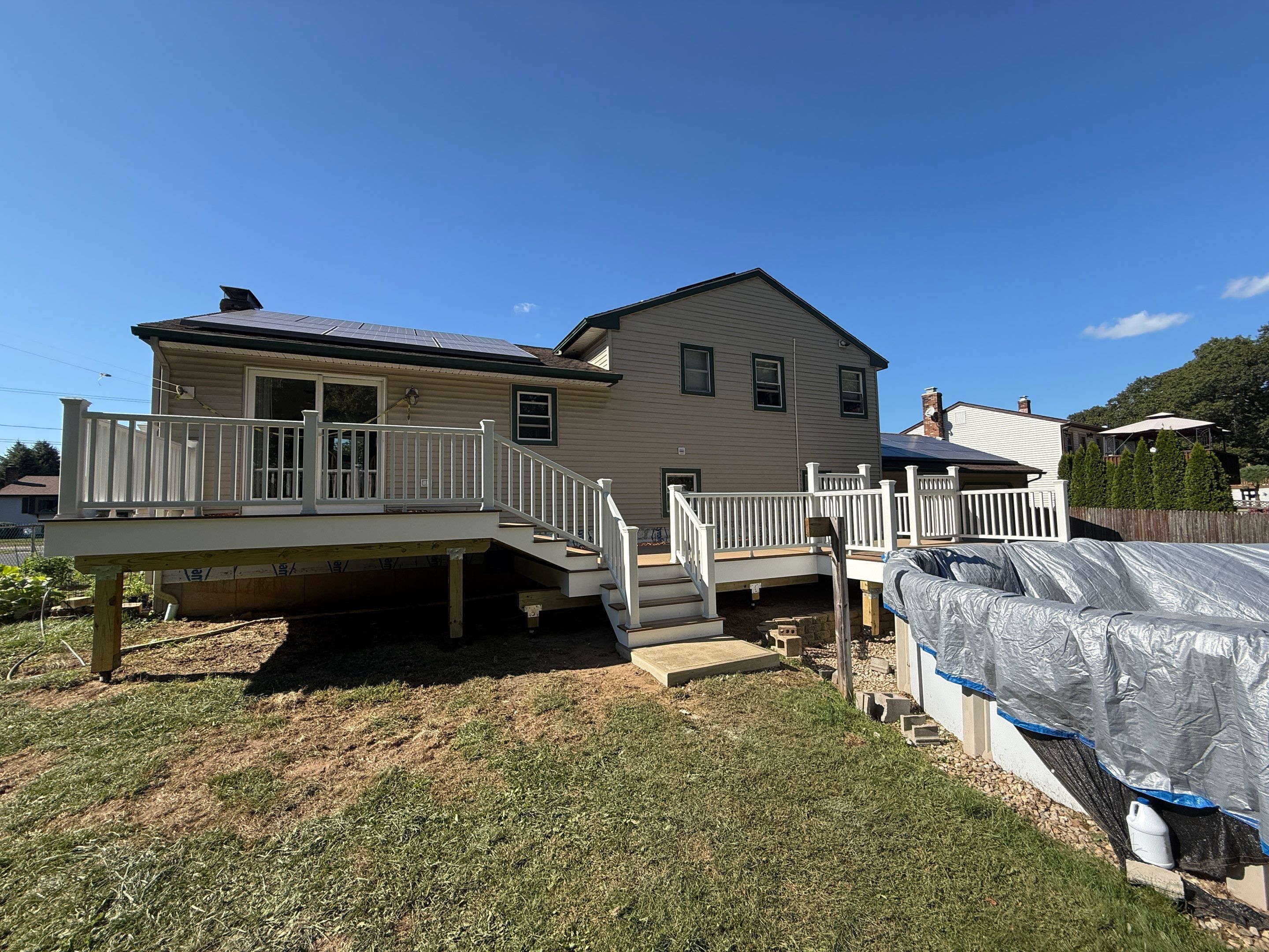 Replacement pool deck with Trex Lineage Carmel and Transcend railings by DiGiorgi Roofing and Siding Inc