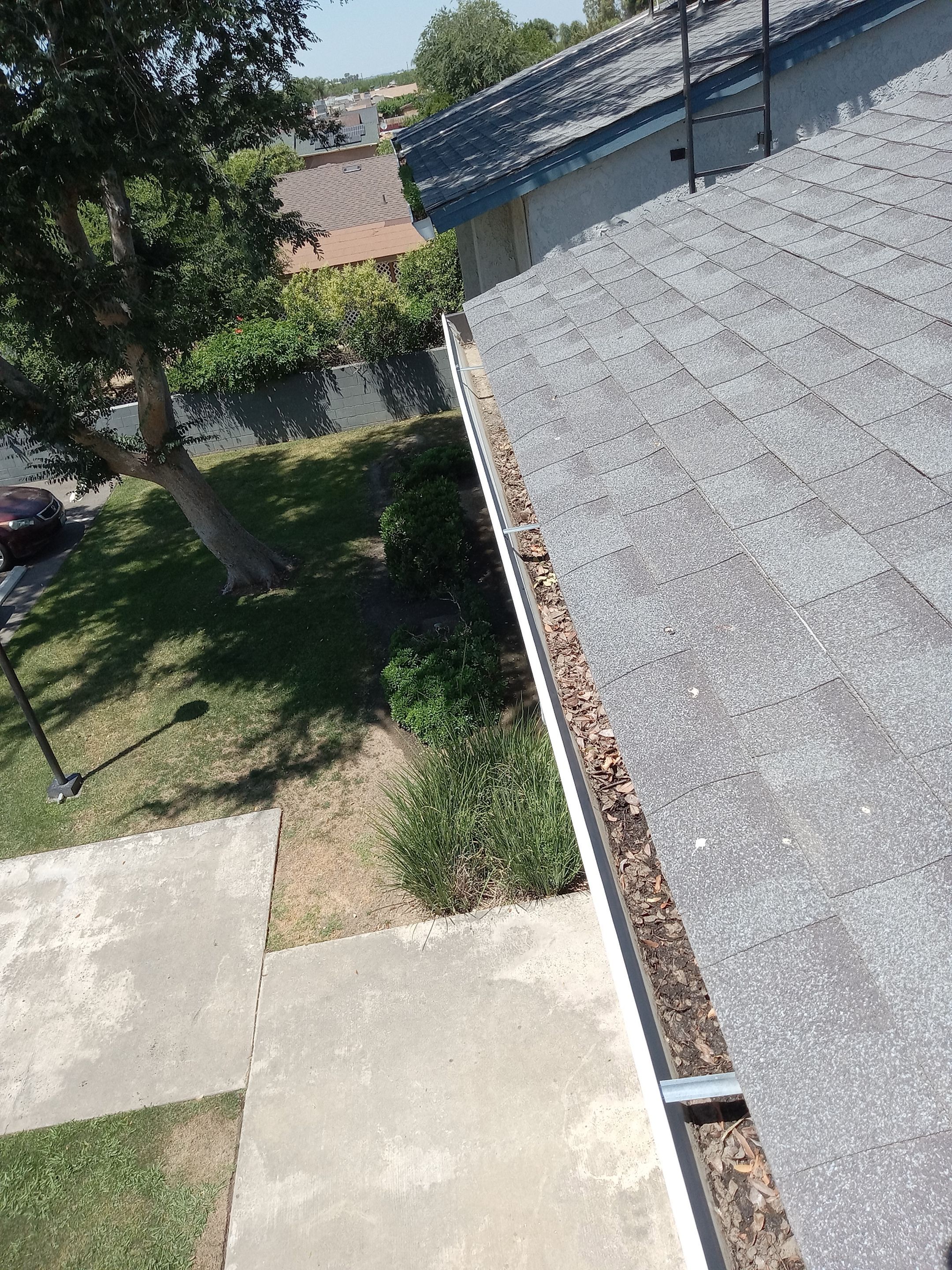 Commercial gutter cleaning Corcoran, CA before photo with filled gutters