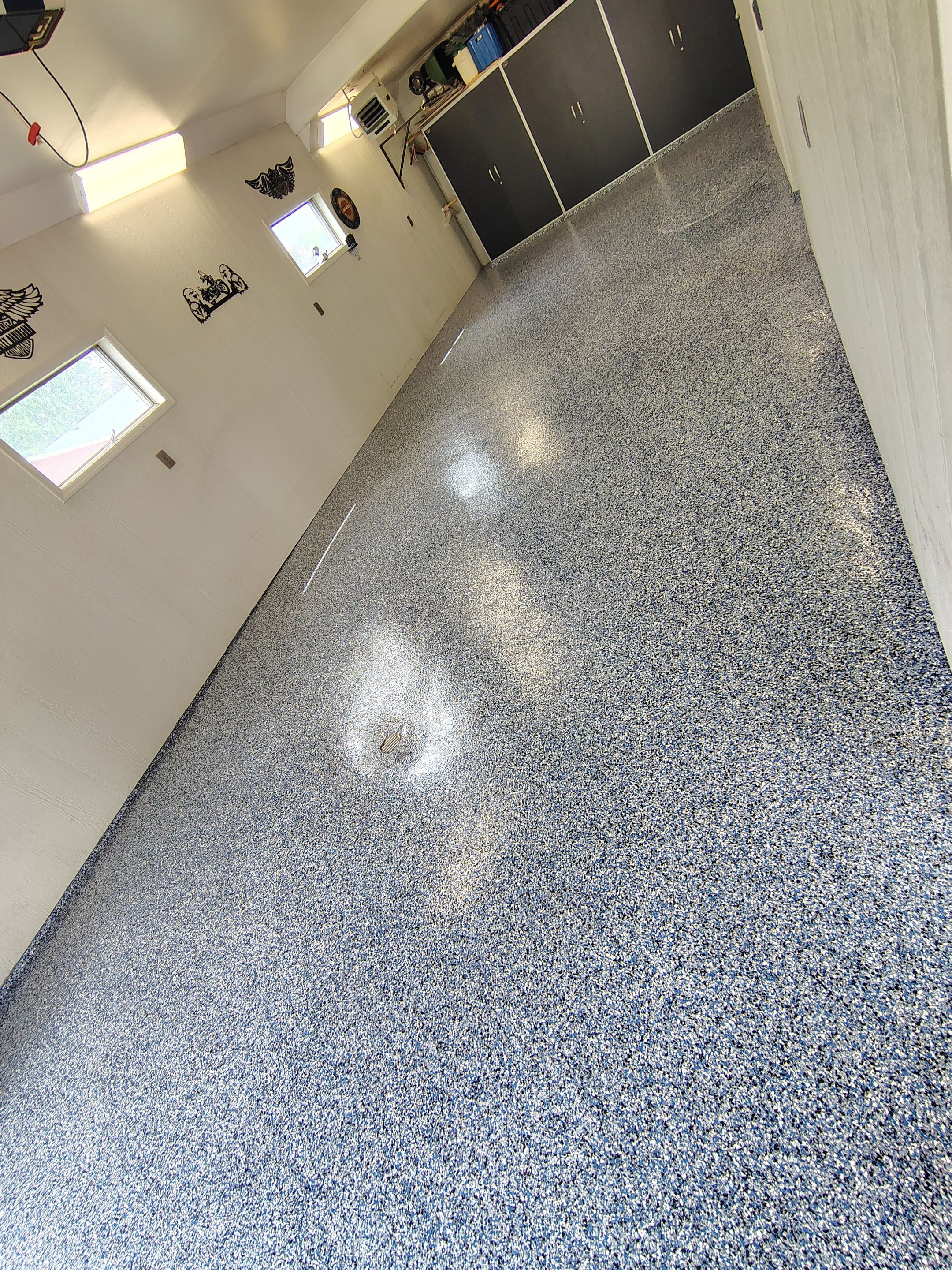 Custom Grey Flake Epoxy Garage Floor Installation in Remsen by Select Painting, Coatings & Garage Cabinets