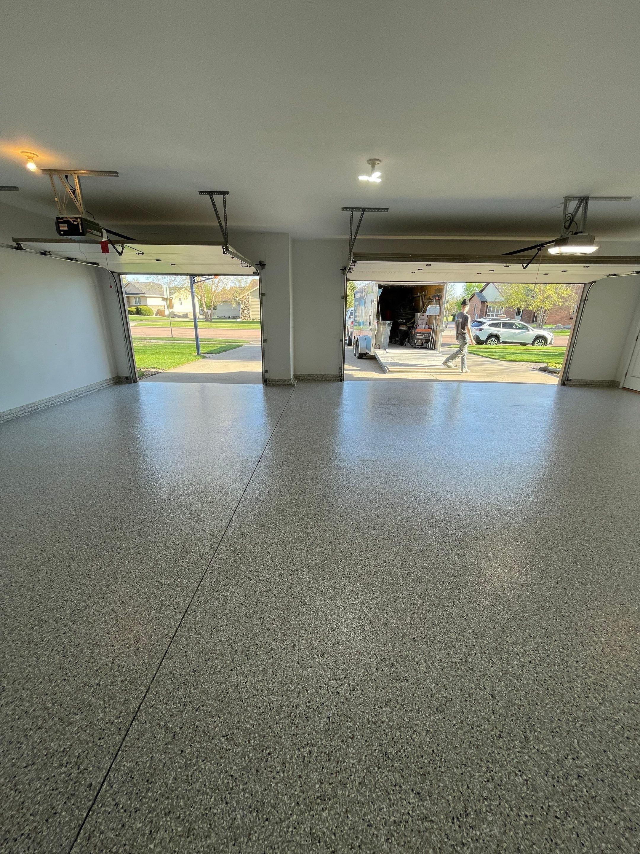 Yankton Garage Floor Restoration with Gray Speckled Epoxy Coating by Select Painting, Coatings & Garage Cabinets