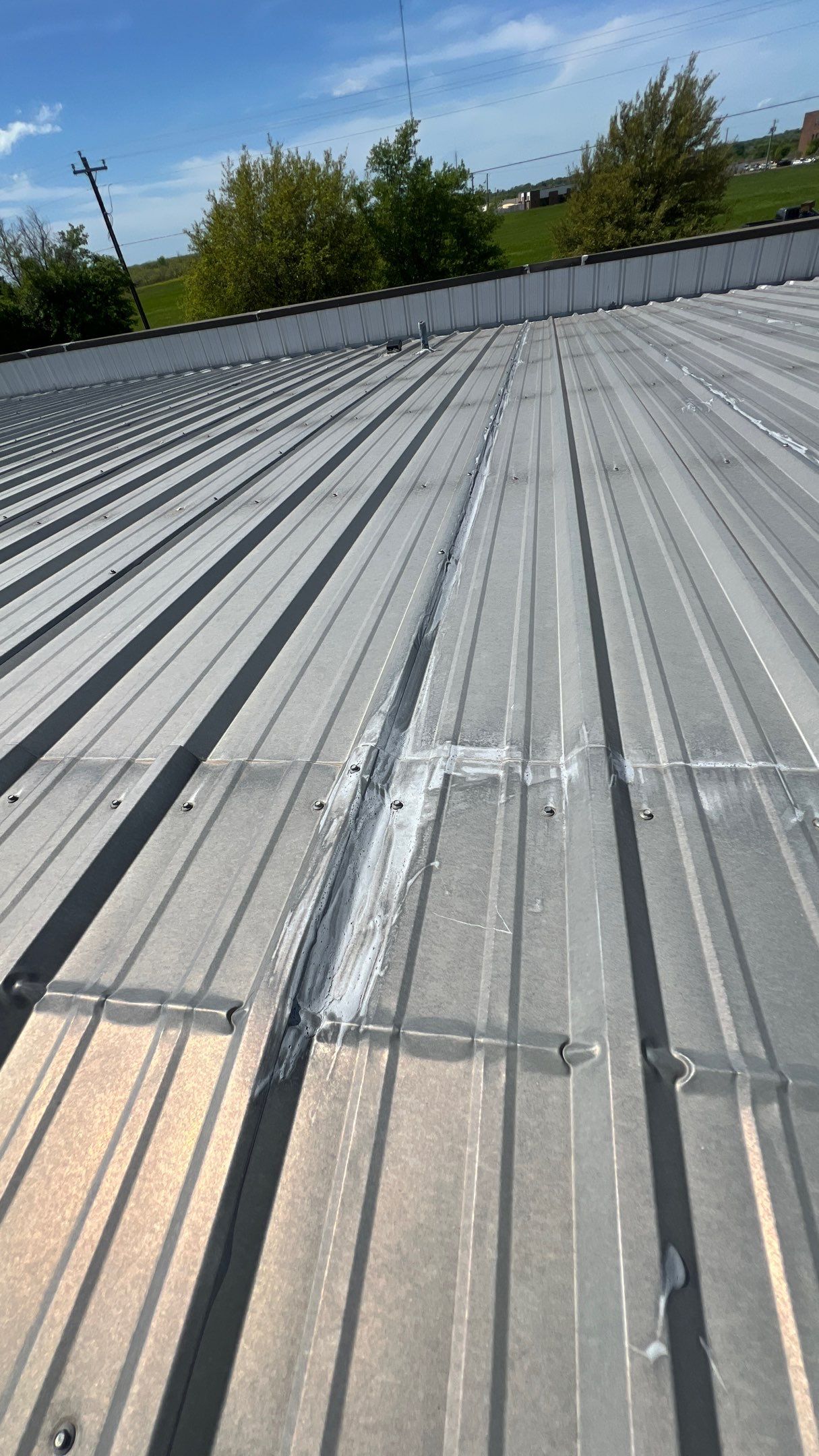 Commercial Roofing Installation using TRP #924 Eterna-Sil Premium Silicone Roof Coating by Harvey Roofing & Construction