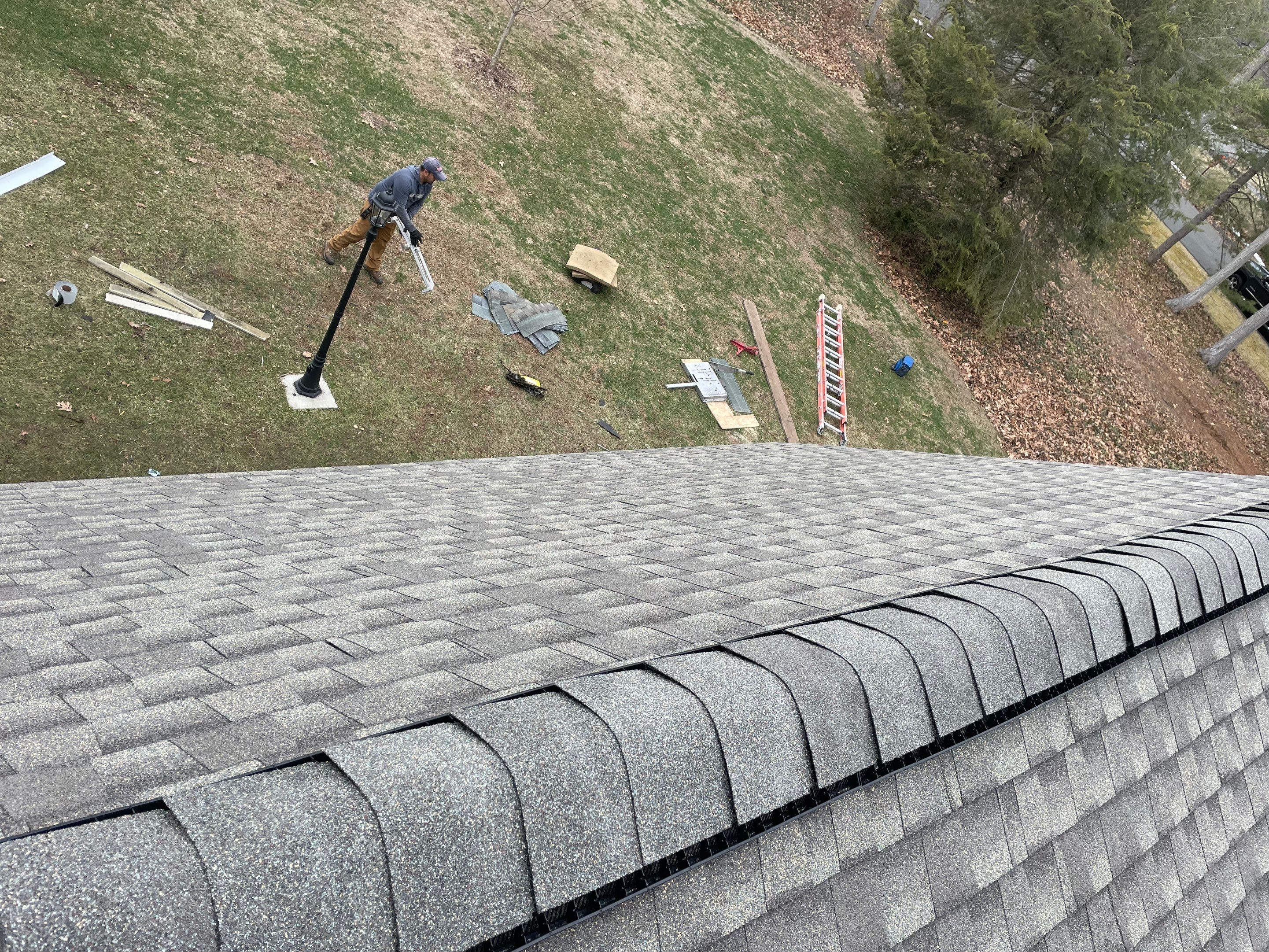 Asphalt shingles meet sleek siding in Guilford. by DiGiorgi Roofing and Siding Inc