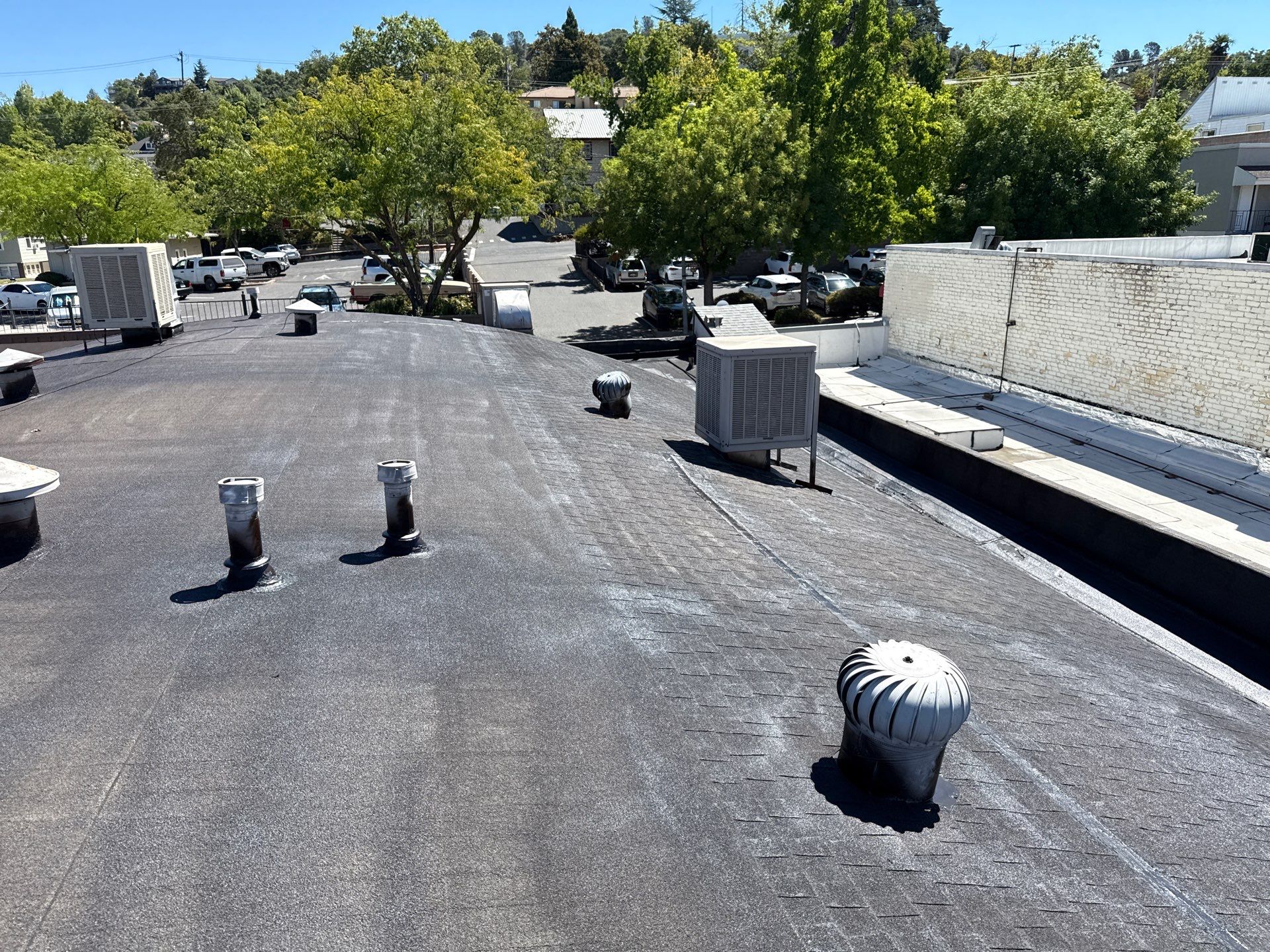 Foam and coatings on commercial roof by Straight Edge Roofing Inc
