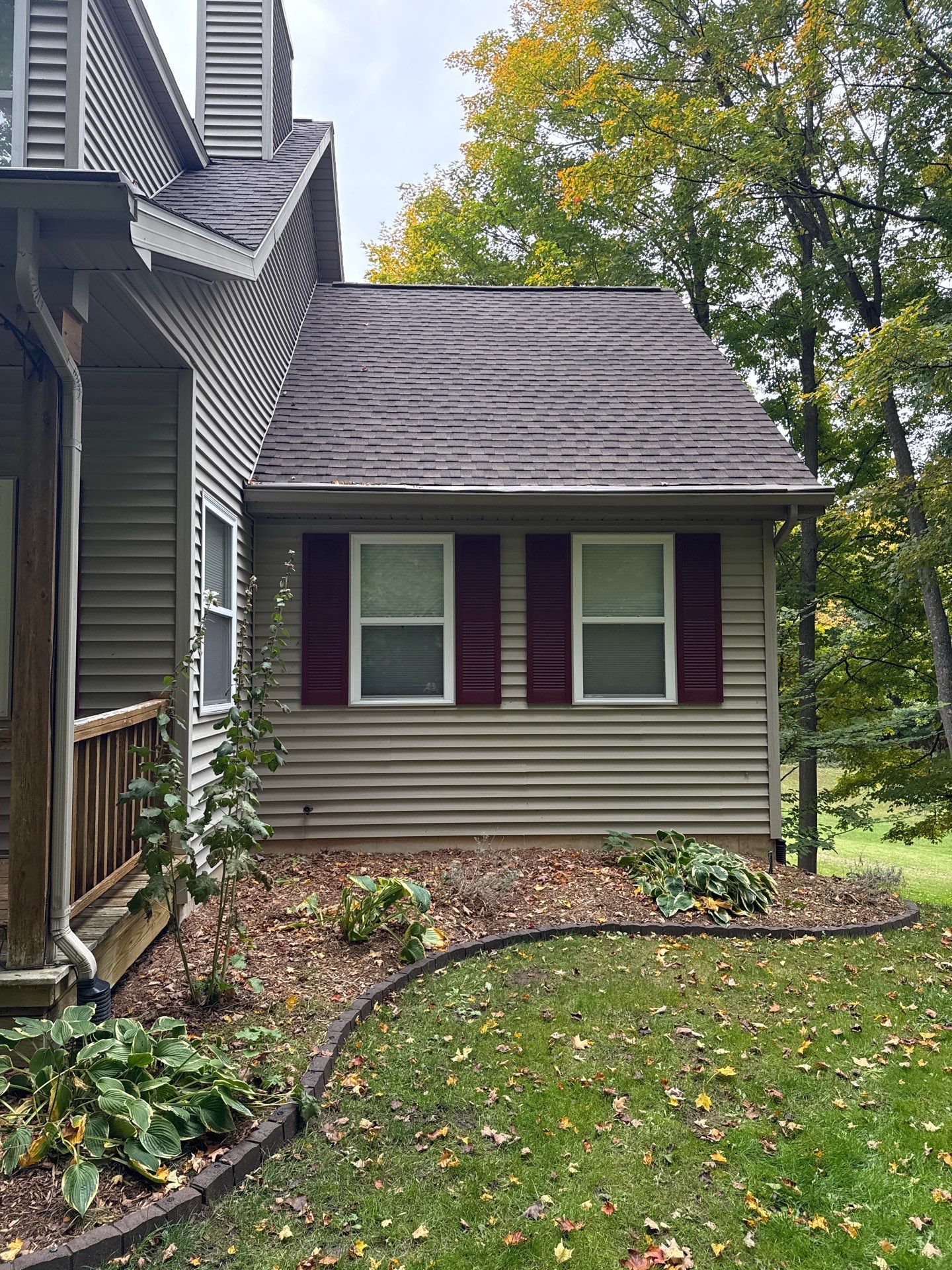 Traverse City Gutter Helmet Installation on a Shingled Roof Home by Rainbow Seamless Systems