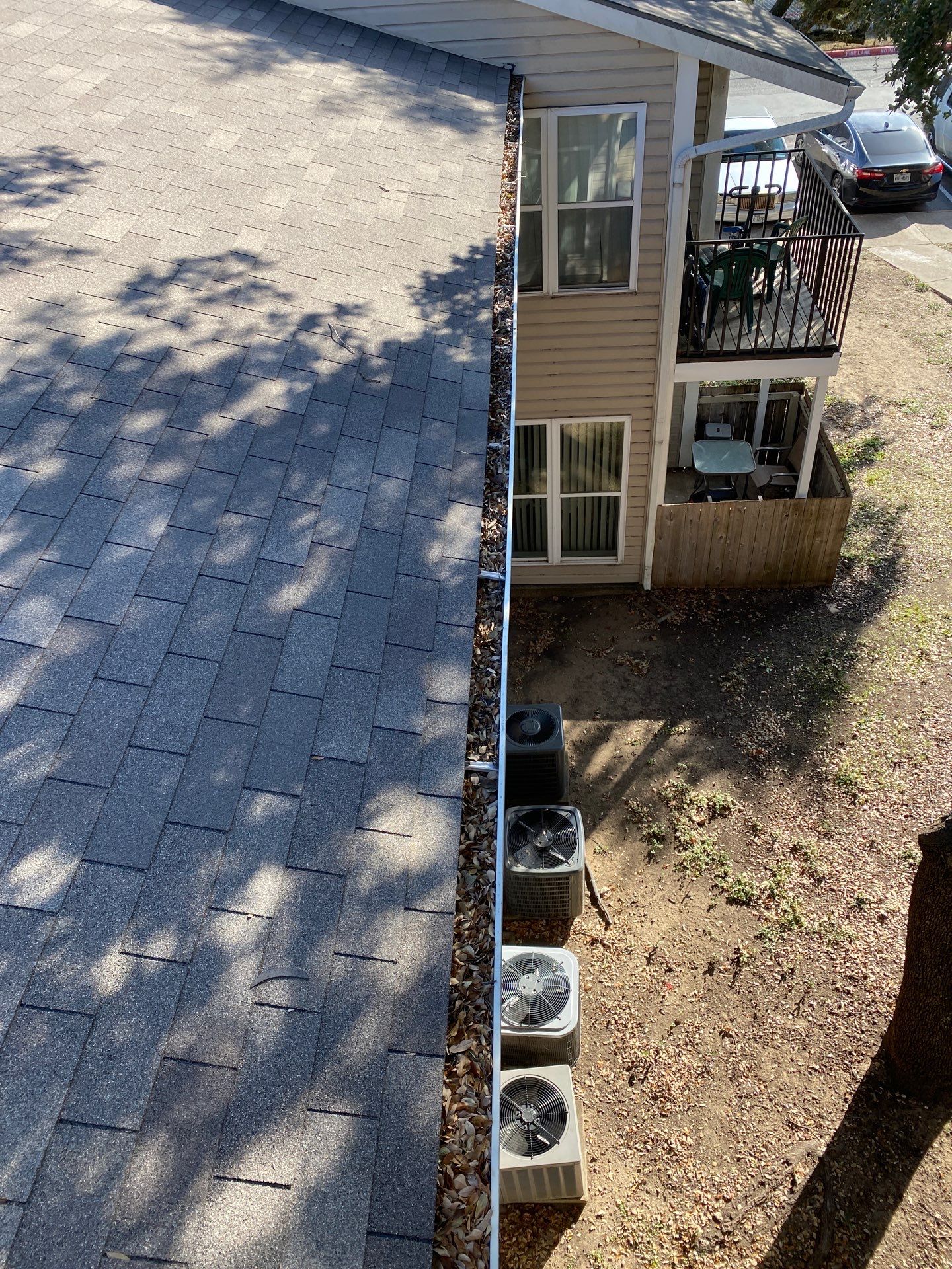 Commercial gutter cleaning Laredo, TX before photo with filled gutters