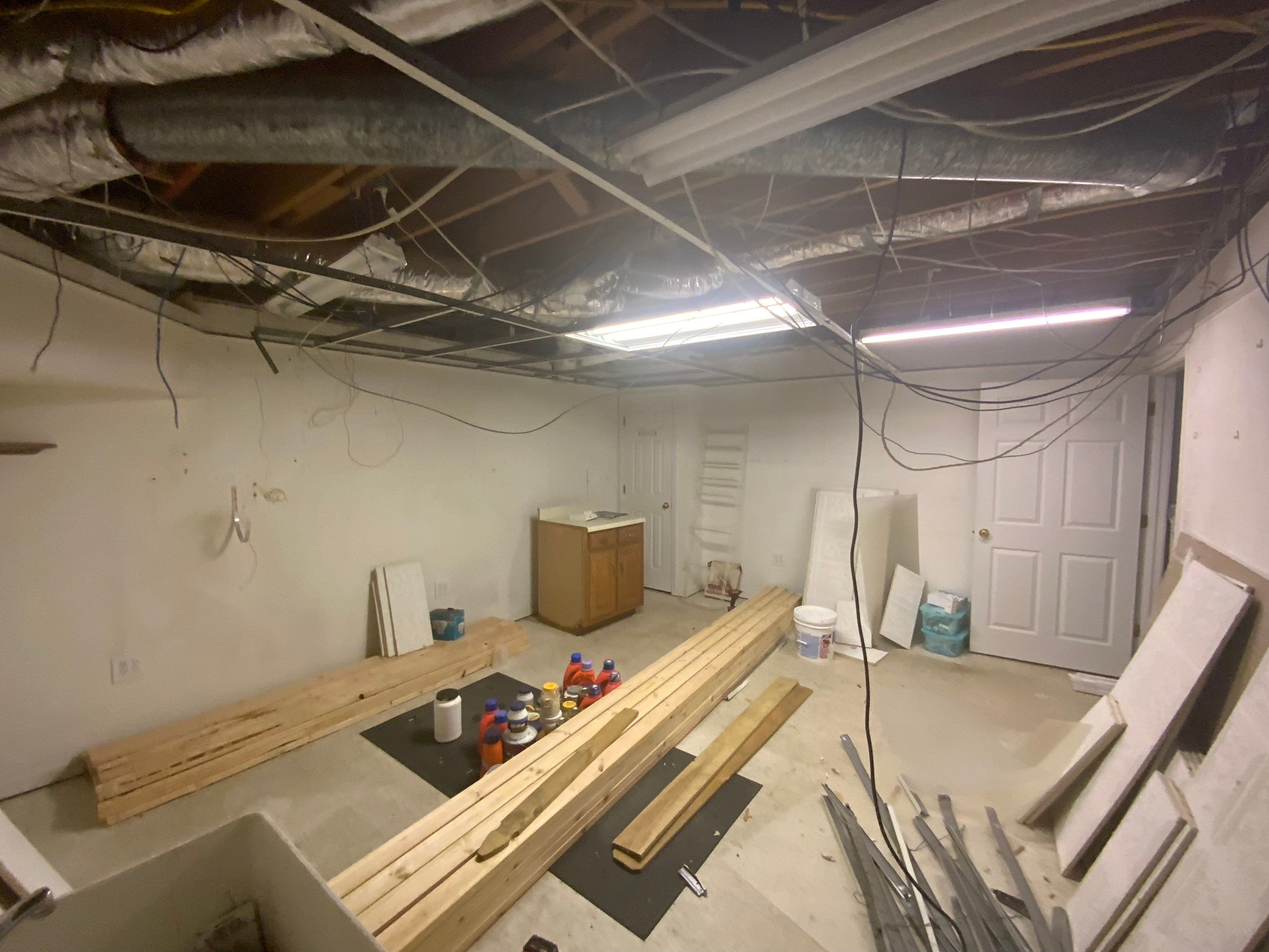 Finished Basement Room Transformation with Wood-Look Flooring in Roswell by Swift Home Renovations