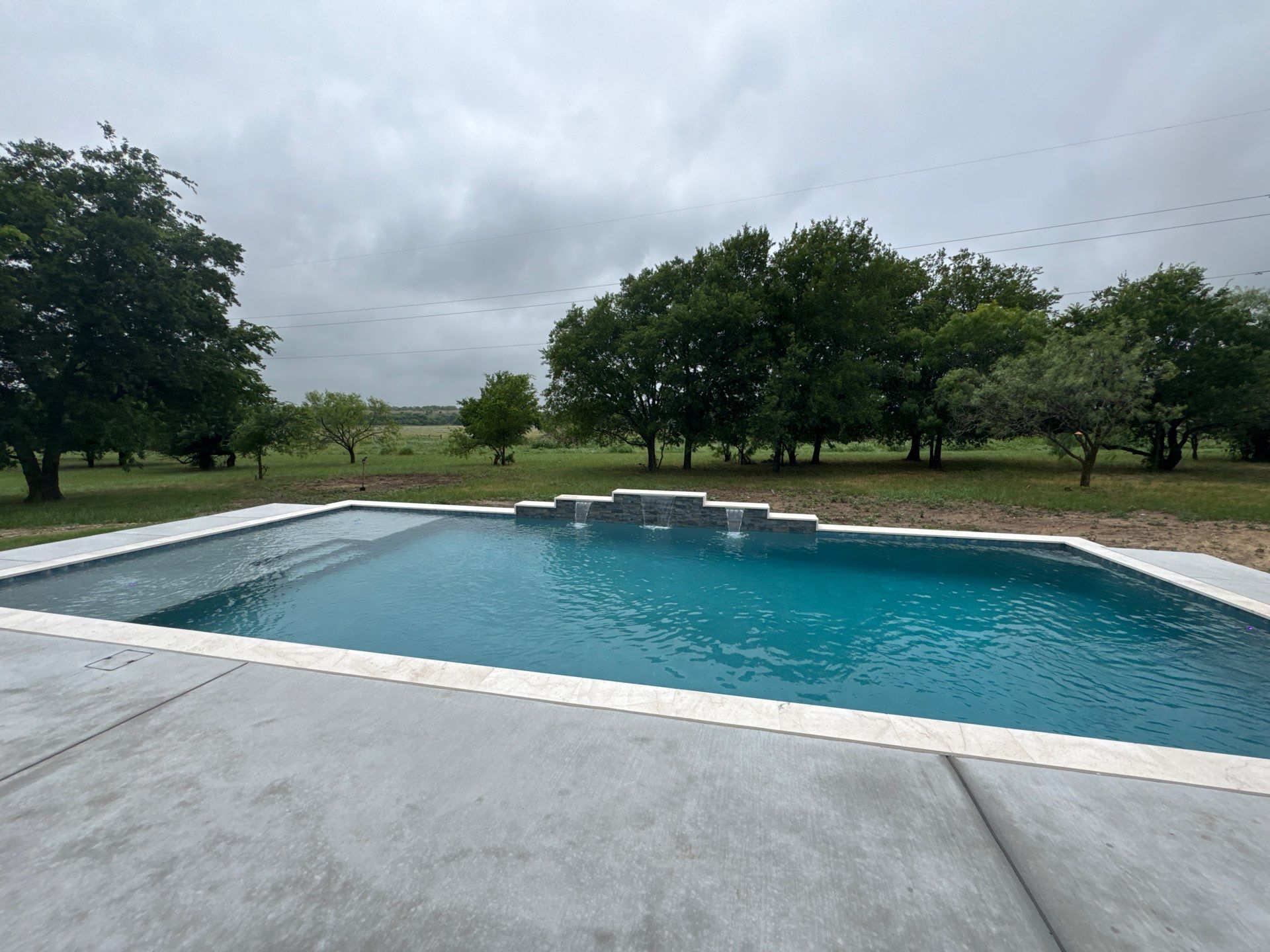 Expansive Geometric Pool with Countryside Views by Pinnacle Pools and Spas - DFW