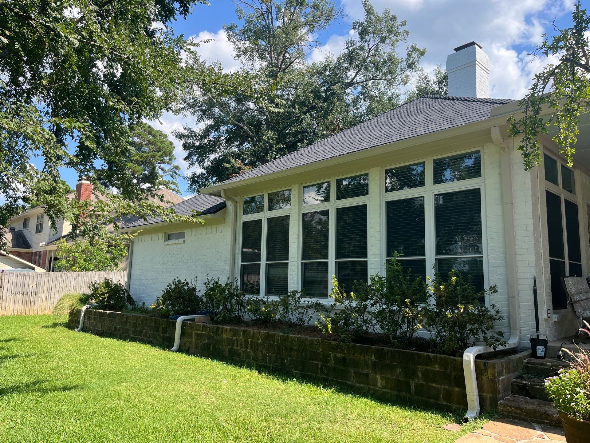 Exterior Painting in Tyler, TX | Brick House with White & Blue Finish by Quality Coats Painting