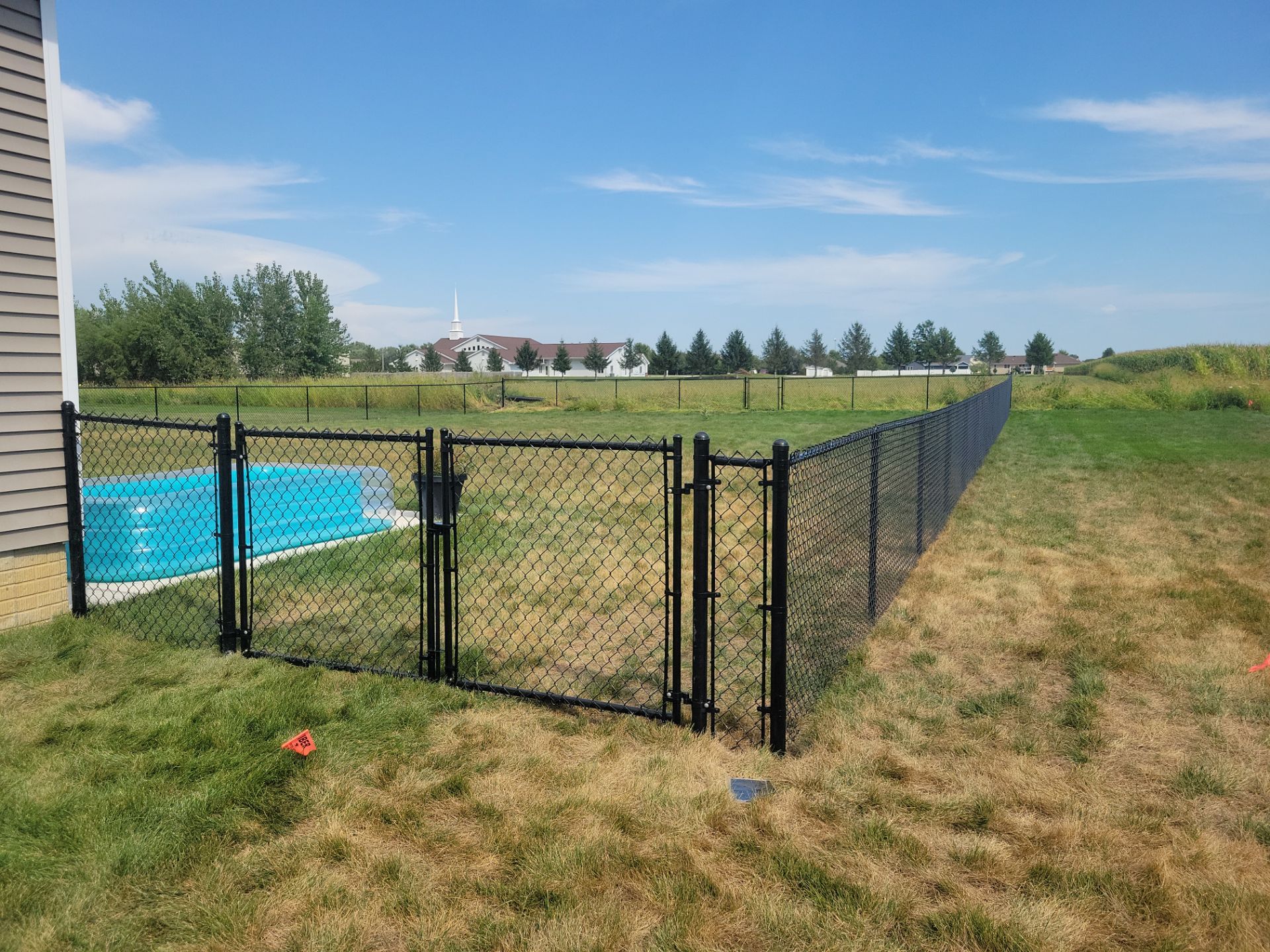 Residential Black Chain Link Fence Installation in Jesup by Perfect Picket Fence and Stain