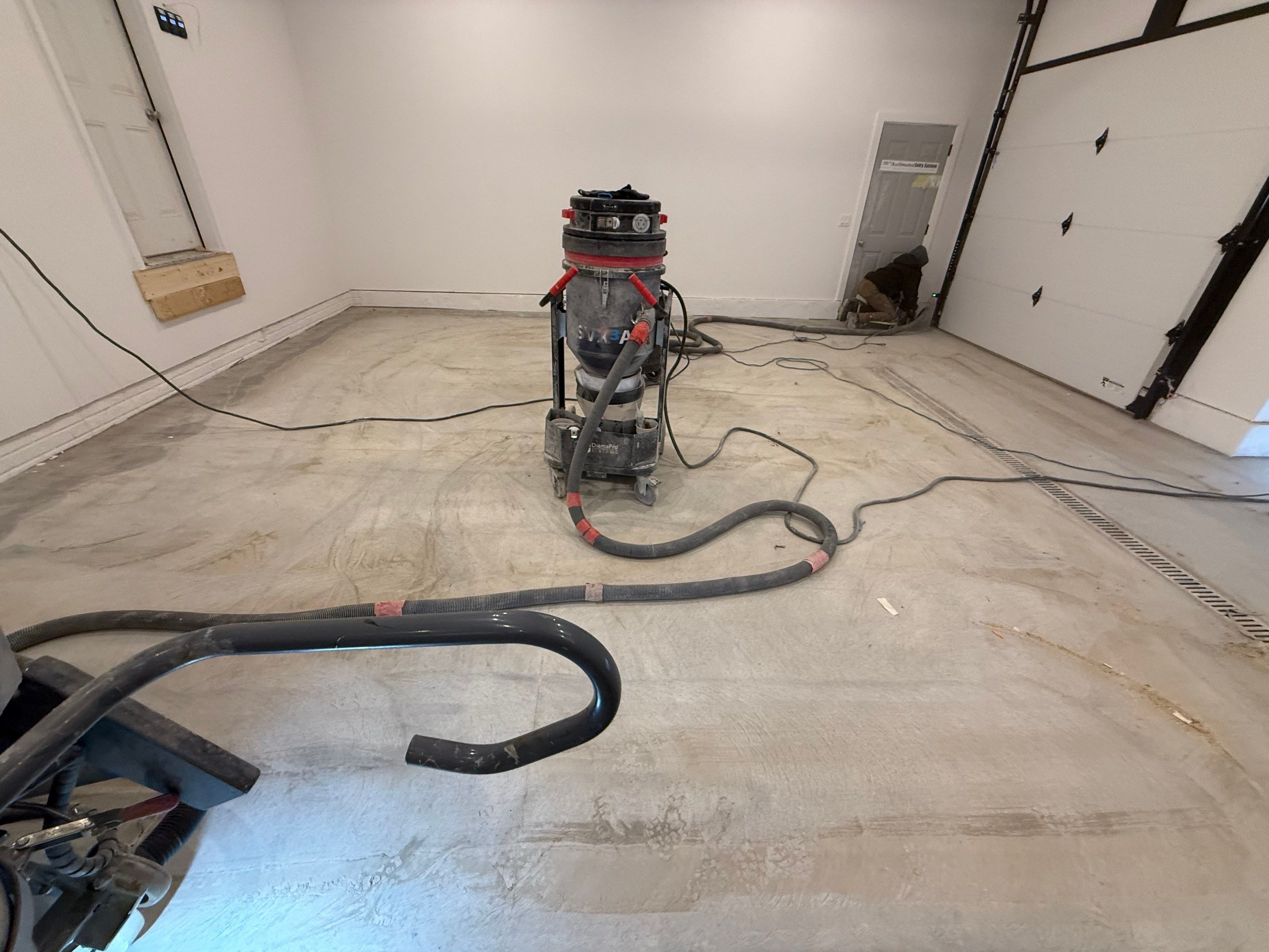 Multi-Car Garage Epoxy Floor Coating and Concrete Finishing in Sioux Falls by Select Painting, Coatings & Garage Cabinets