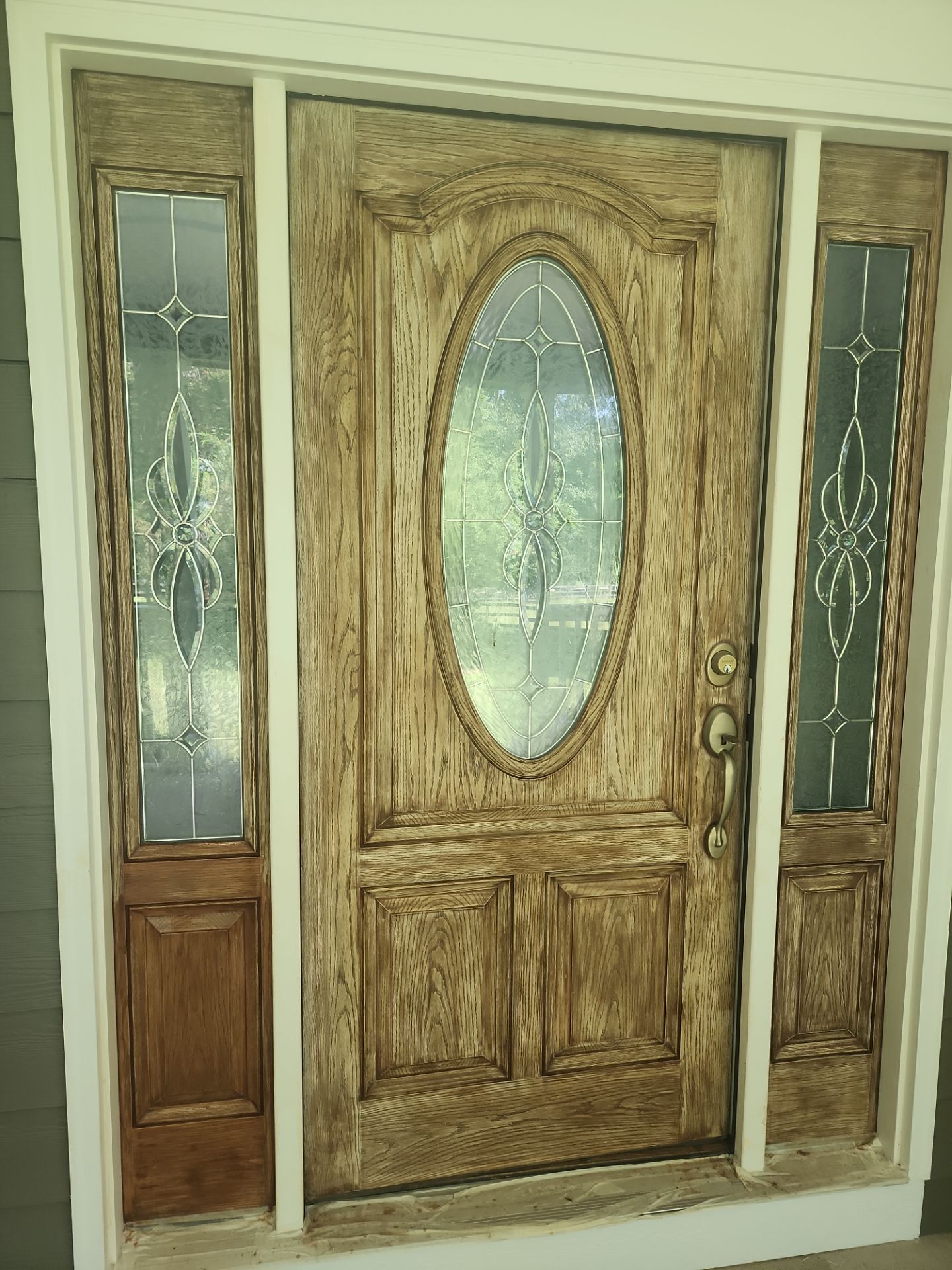 Siding replacement, exterior painting, and front door staining. by GonzalezPainters & Contractors Inc