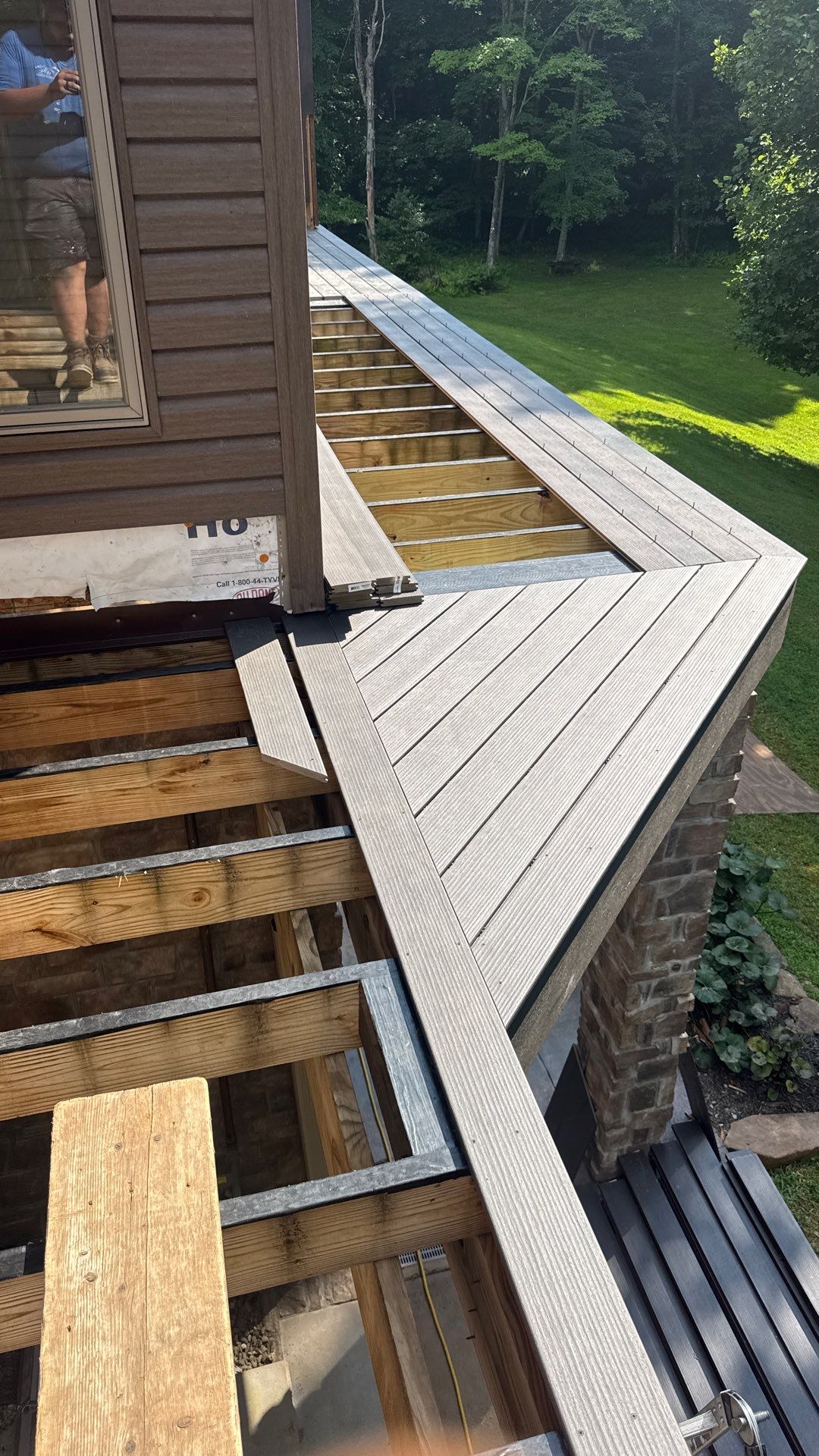 Custom Composite Deck Construction with Stone Pillars in Fayetteville by Walnut Hollow Decks & Outdoor Living