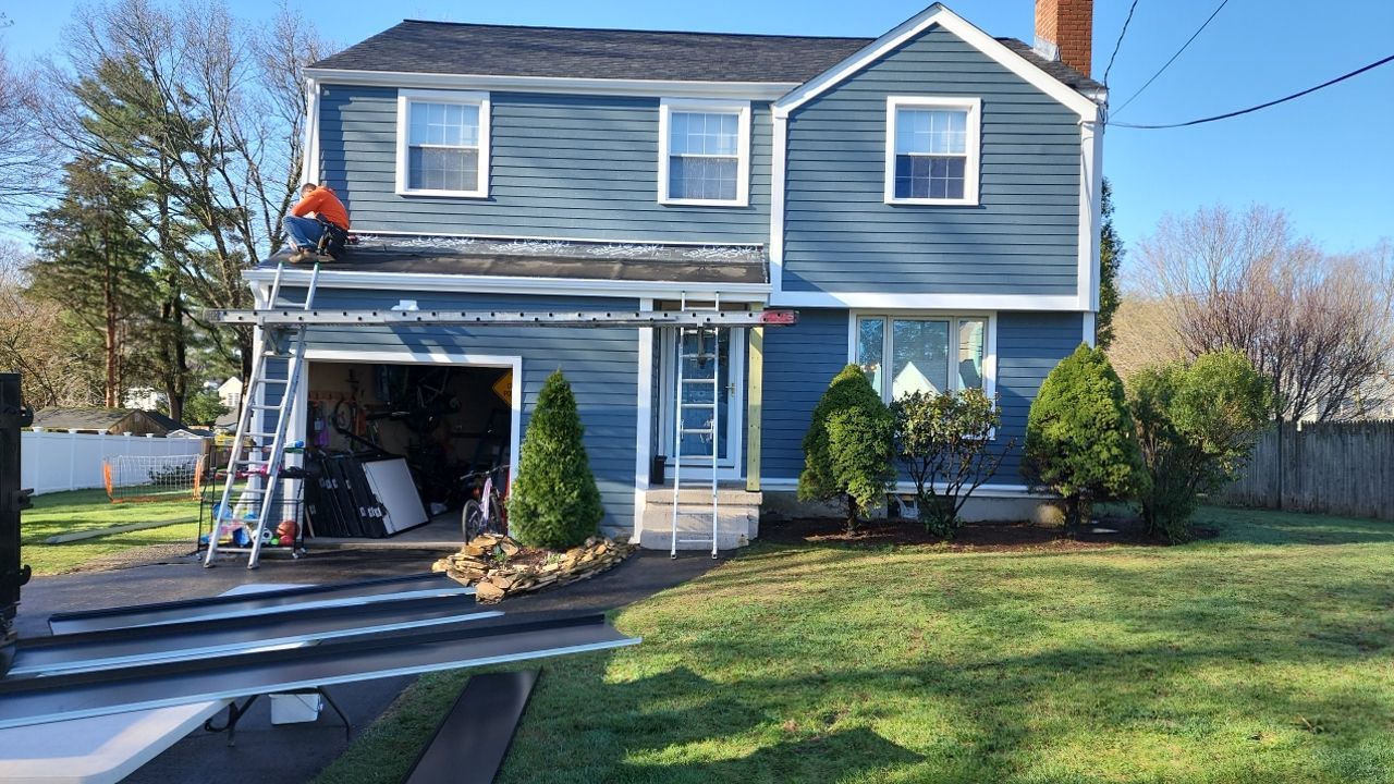 James Hardie siding, new metal roof and couple windows being installed. by UBrothers Construction