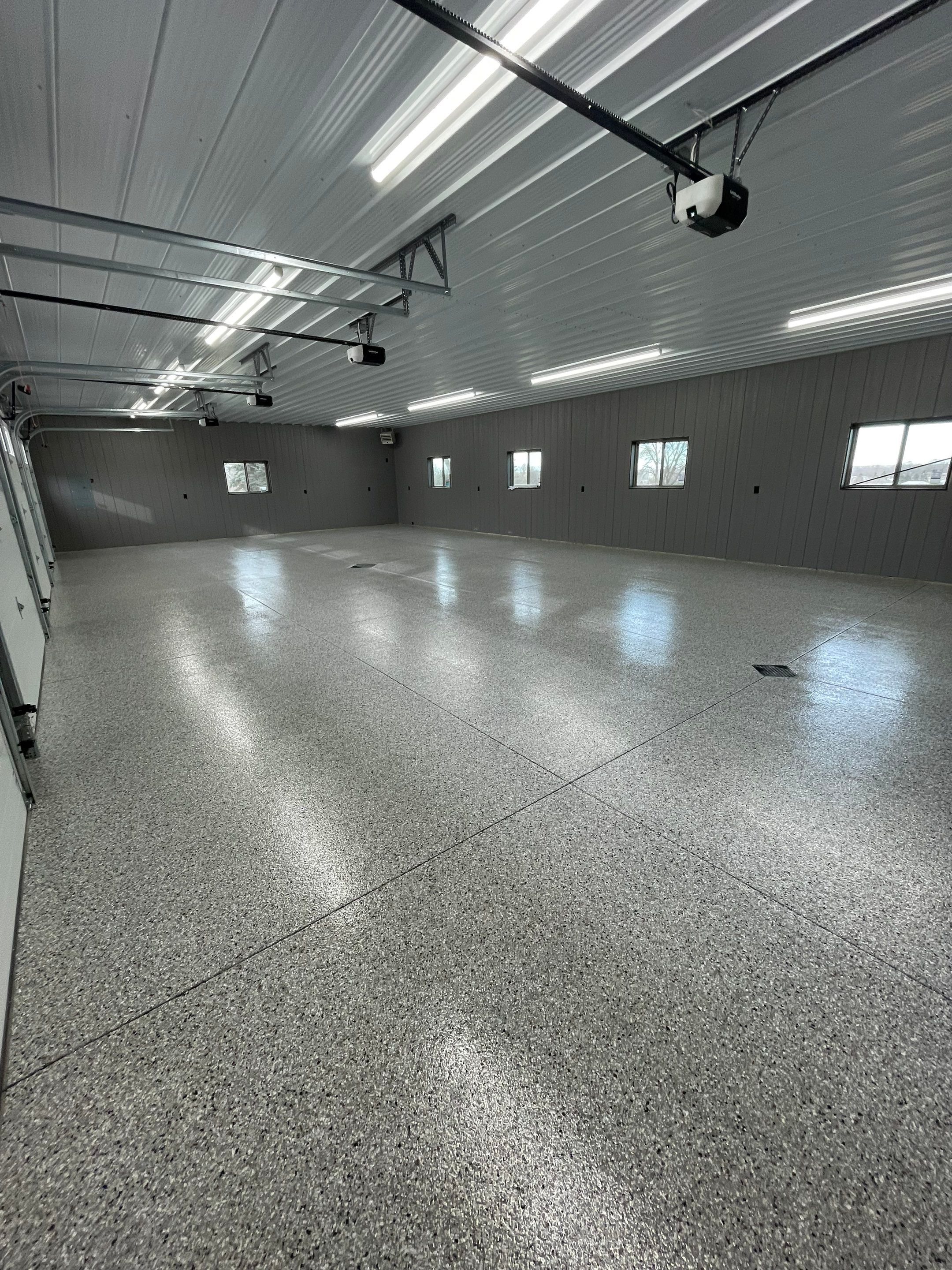 Speckled Epoxy Floor Coating for Large Shop in Rock Valley by Select Painting, Coatings & Garage Cabinets