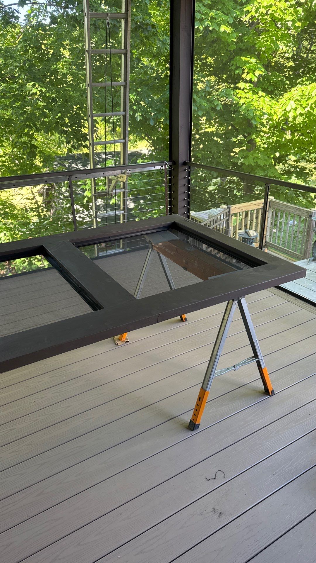 Custom Composite Deck with Stone Fireplace and Modern Cable Railing by Walnut Hollow Decks & Outdoor Living