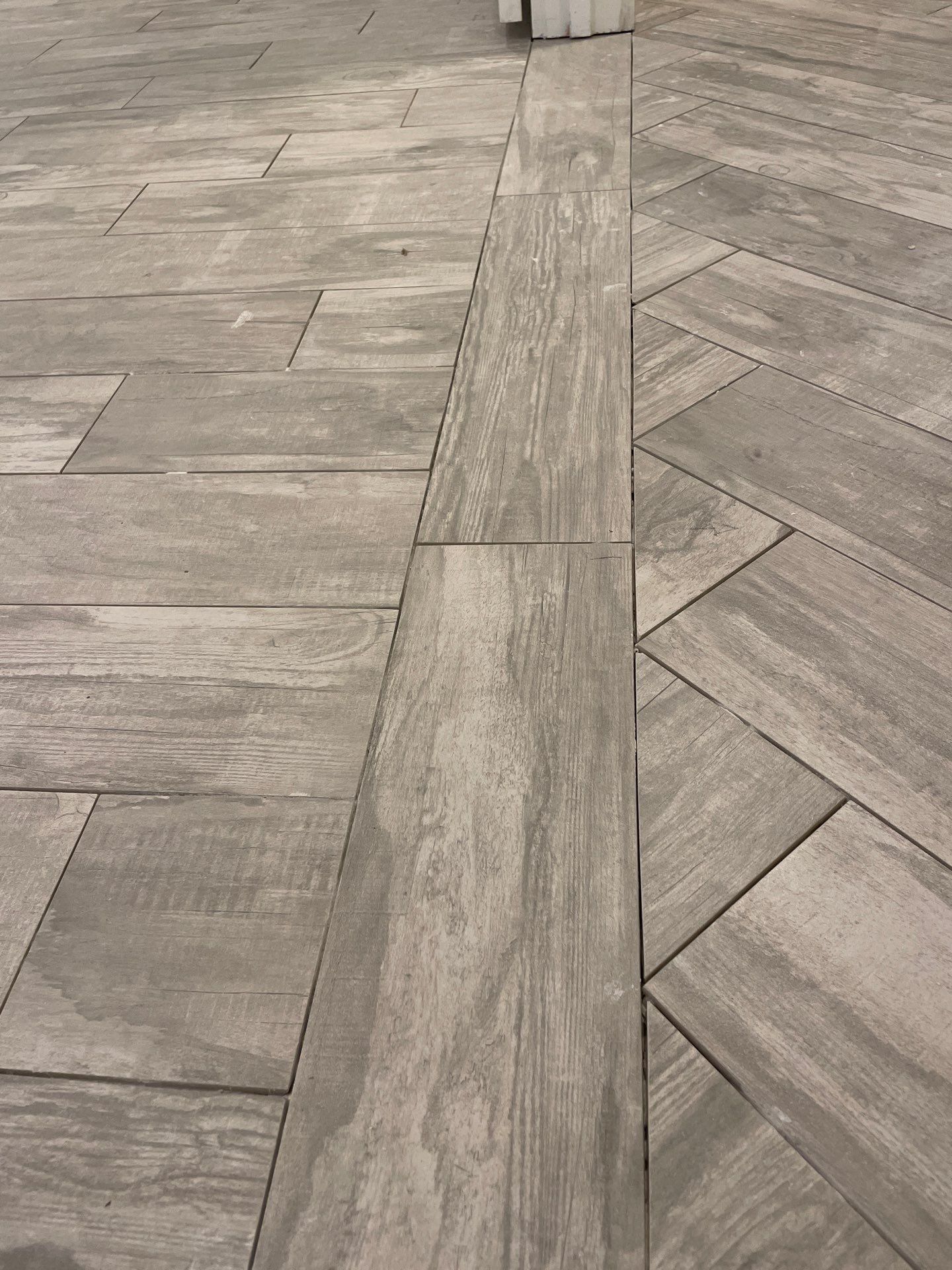 Herringbone and plank tile by Footprints Floors of East Atlanta