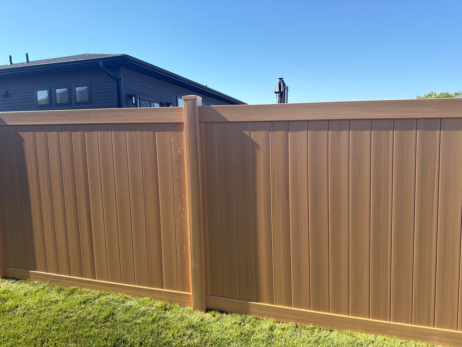 Residential Cypress Vinyl Privacy Fence Installation in Cedar Falls by Perfect Picket Fence and Stain