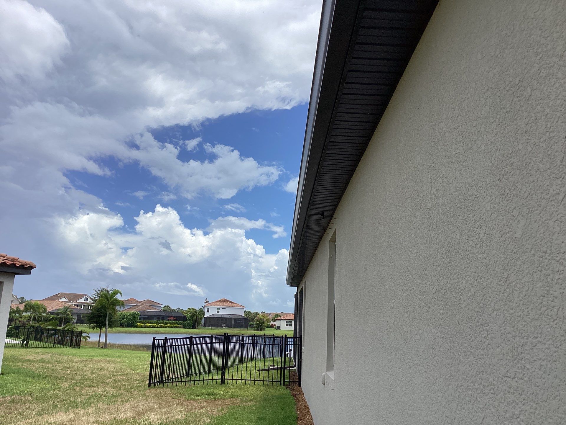Musket brown seamless gutters with splash guards, new downspouts, and extensions in Bradenton, FL by Gutter Professors