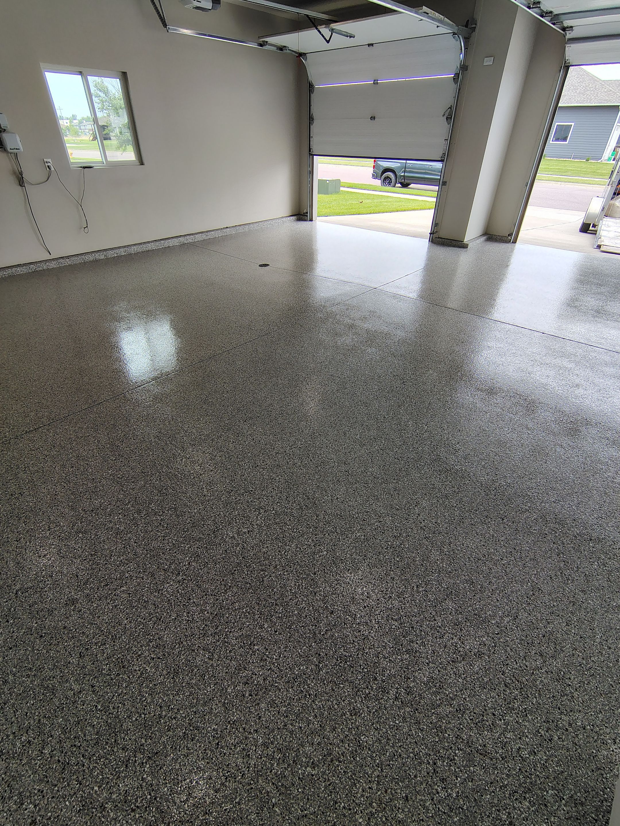 Grey Speckled Epoxy Garage Floor Coating in Sioux Falls by Select Painting, Coatings & Garage Cabinets