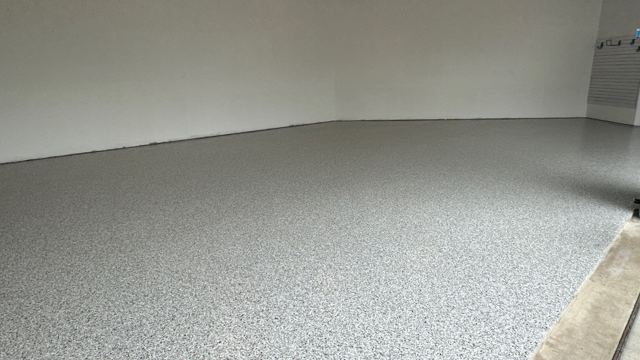 Jon S. transformed his garage with a new floor, slotwall & Cabinets! by Banner Garage