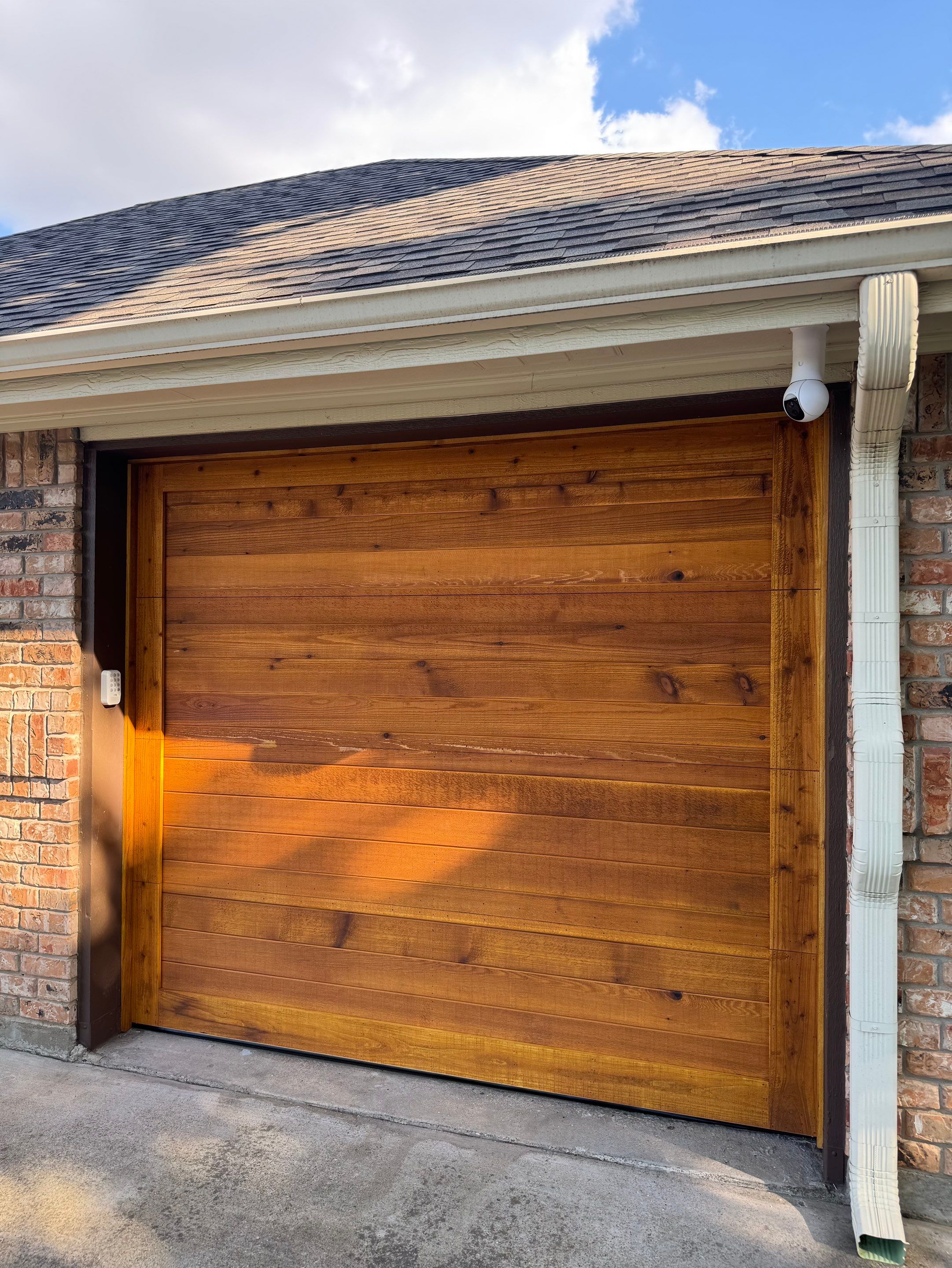 Custom Stained Cedar Garage Door Installation in Grapevine by Meadows Garage Doors