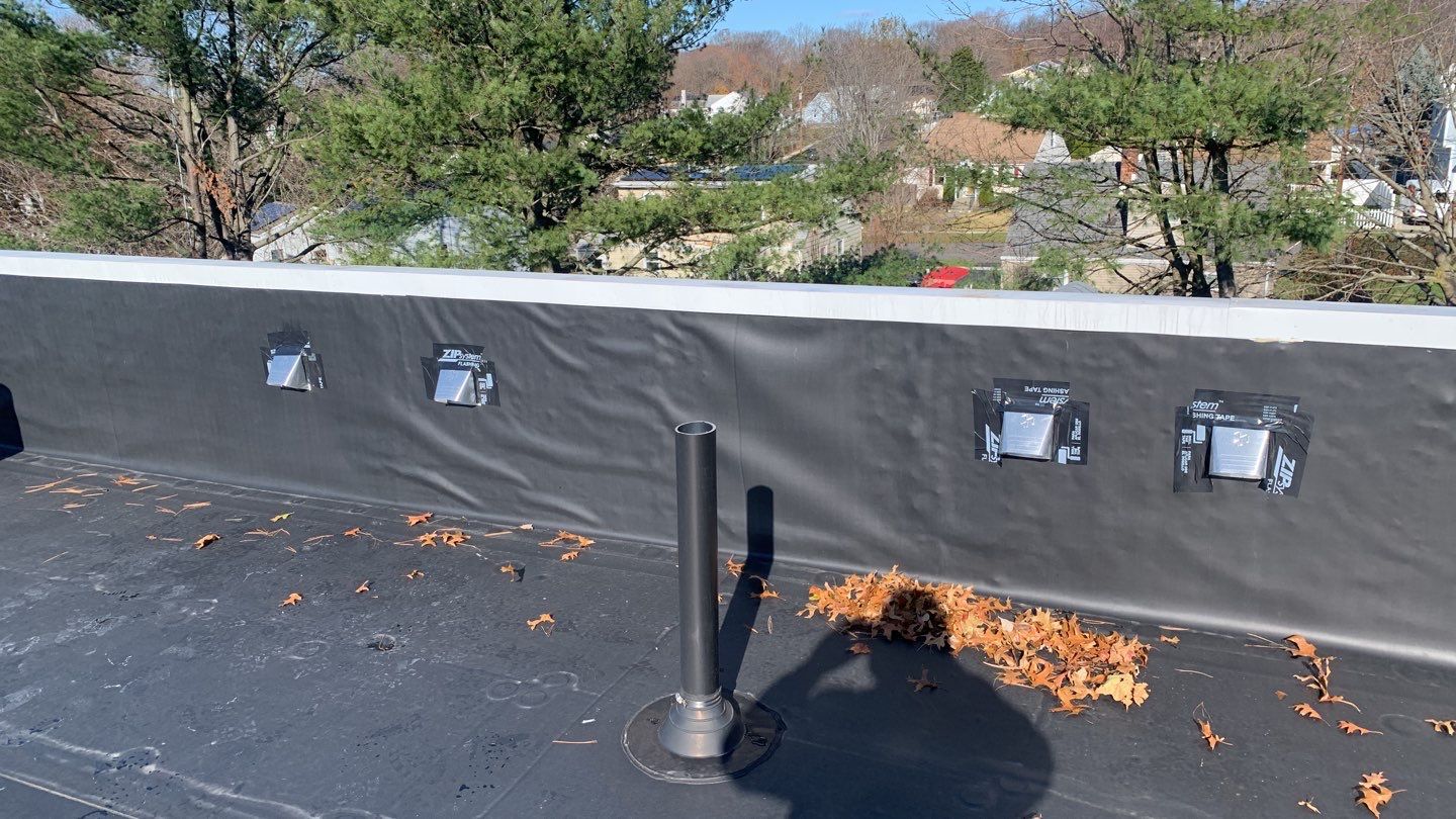 Commercial Roofing Installation using EPDM with white gutters by A Plus Exterior