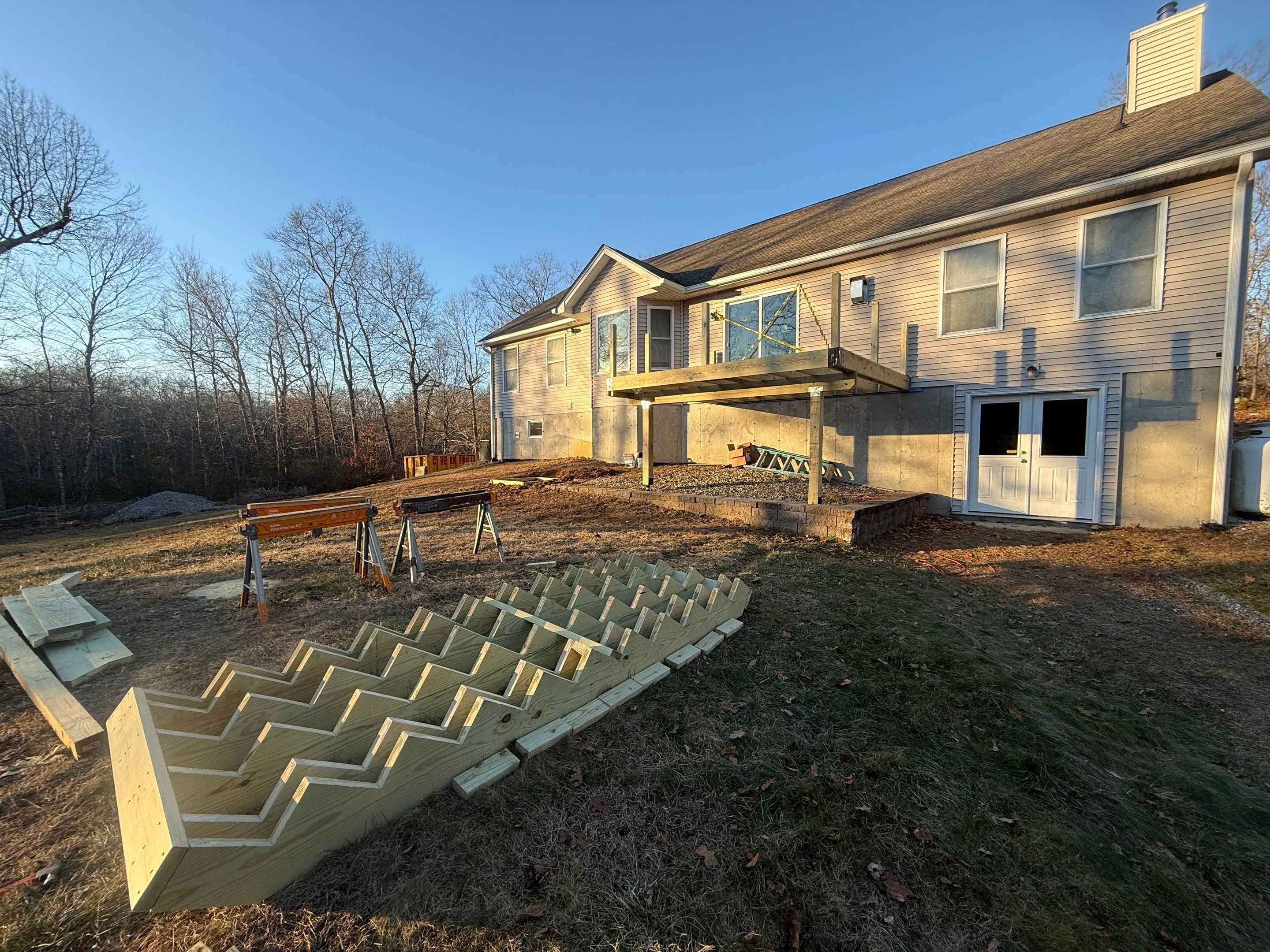 Replacement deck using Trex Transcend Ropeswing and White Transcend railings, with gate by DiGiorgi Roofing and Siding Inc