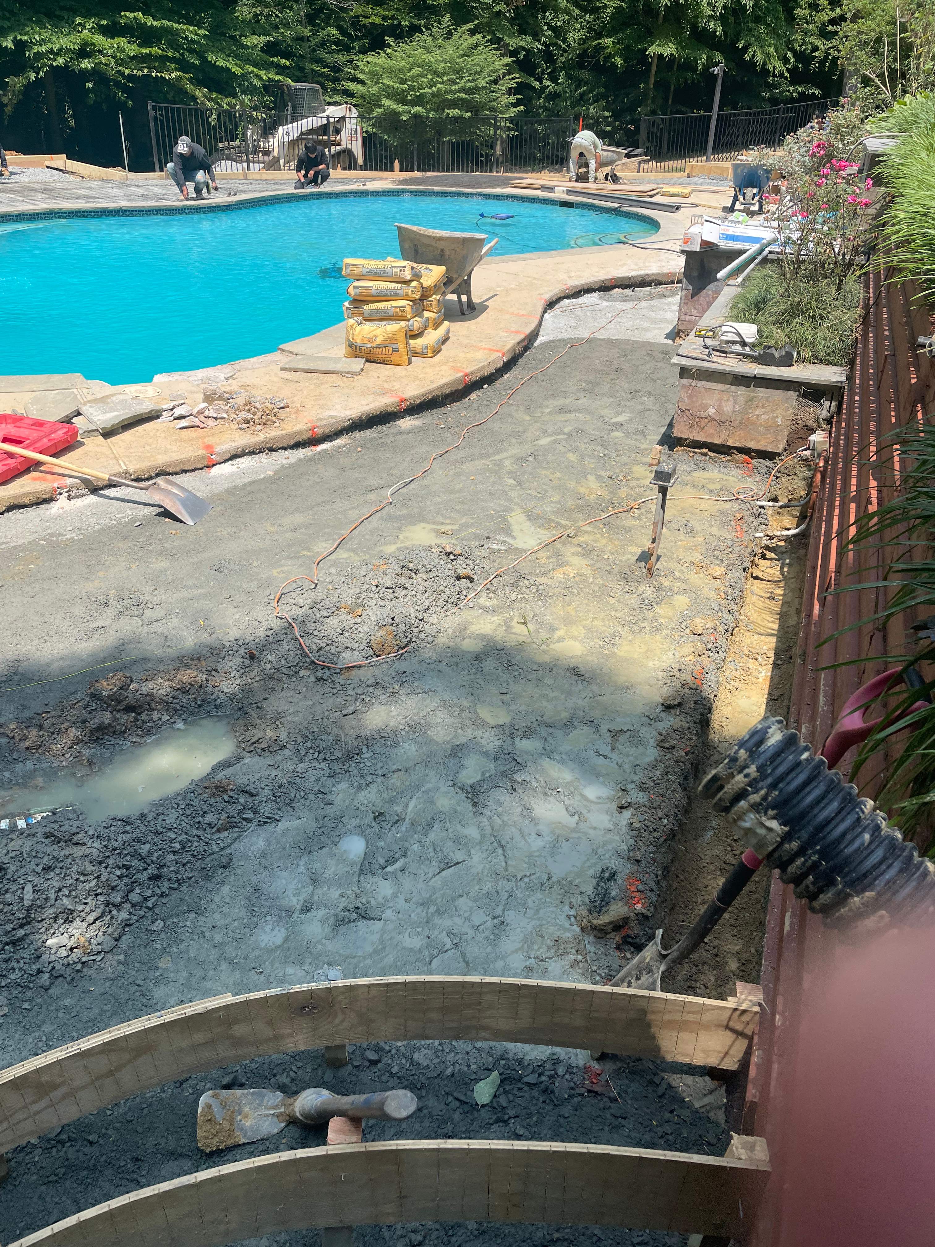 Pool Surround remodel with retaining walls, new waterfall and water slide by Fairfax Contractors, LLC