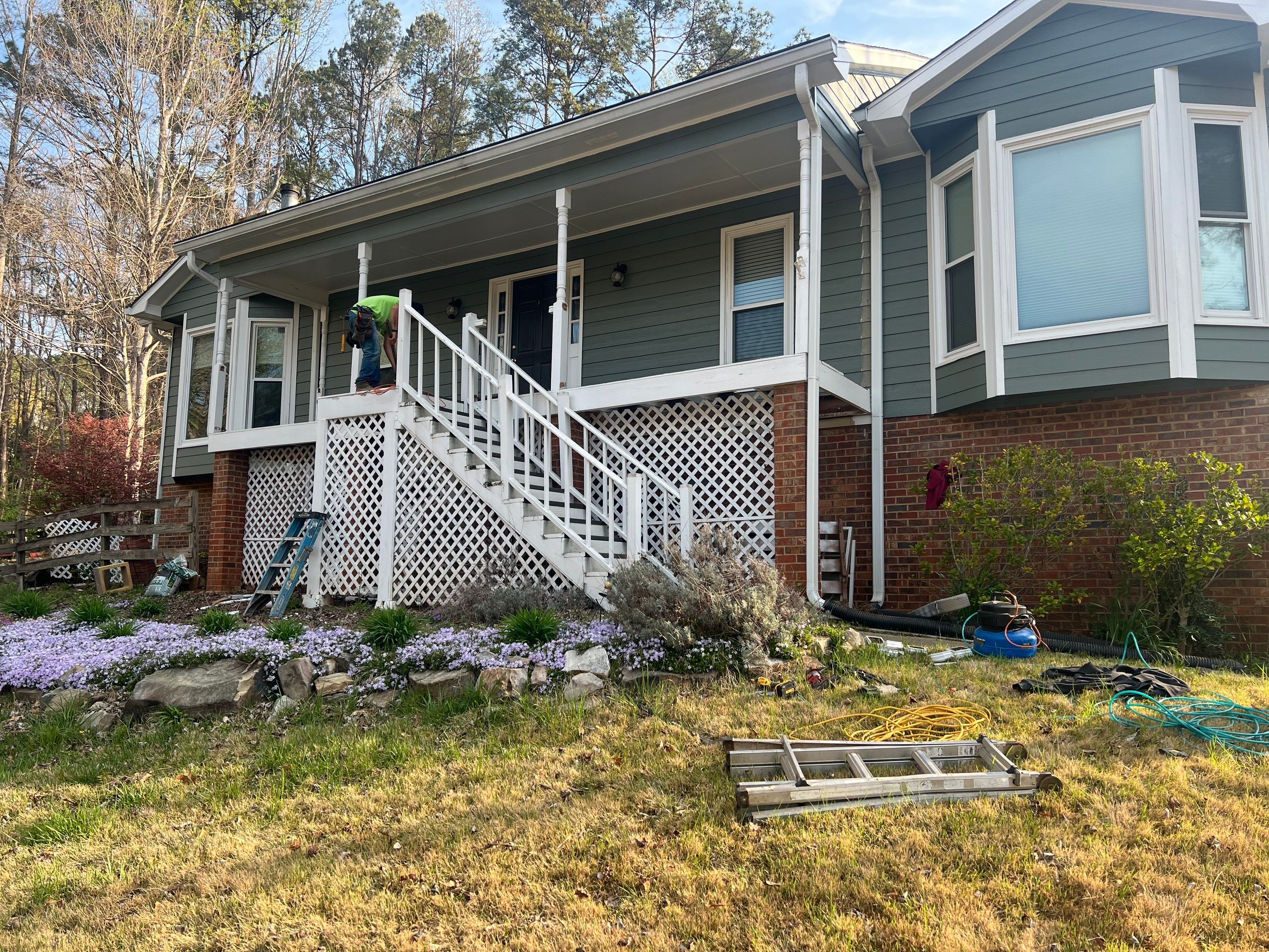 Composite Deck and Porch Renovation With Black Metal Railings by Swift Home Renovations 