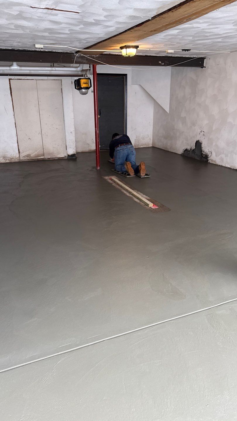 Concrete garage floor replacement with a broom finished apron and wall repair by NG Masonry & Construction LLC