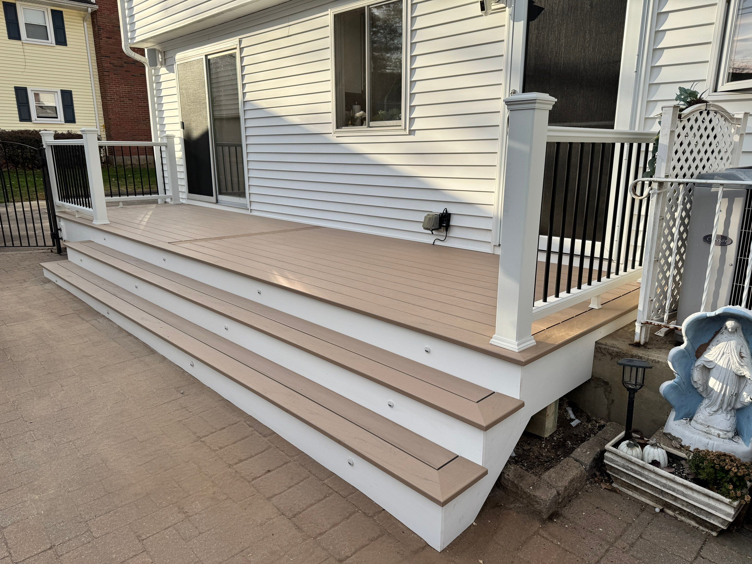 Replacement Deck using Tres Lineage Carmel boards and White Composite railing. by DiGiorgi Roofing and Siding Inc