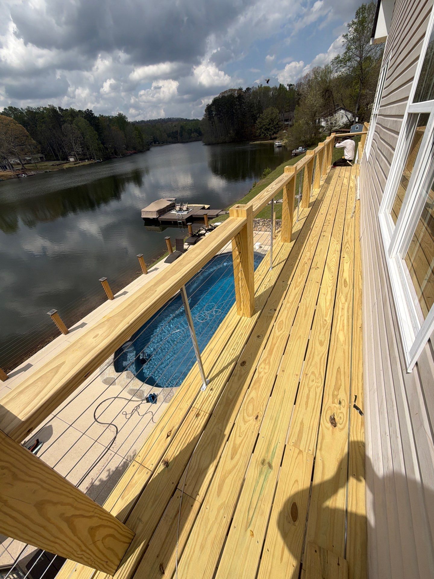 Cumming, GA Lake House Deck Resurface and Extension using Pressure Treated Pine and Skyline Cable Railing by Nelson Exteriors 